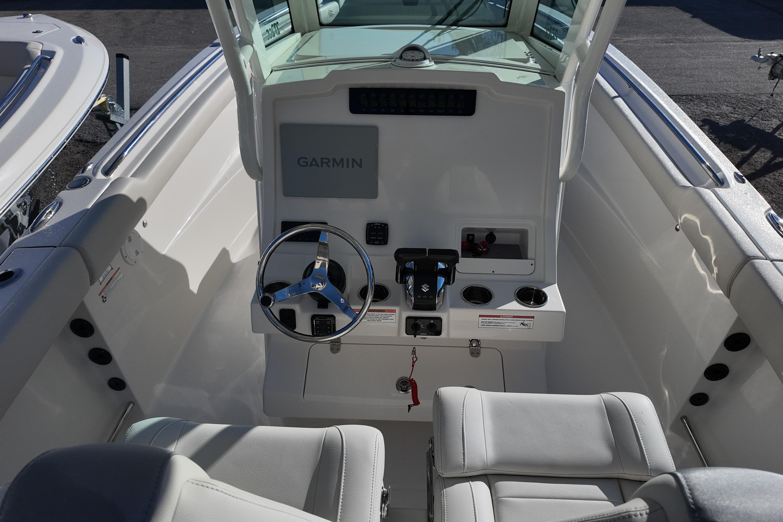 2026 Sailfish 272 CC boat cockpit with Garmin navigation and steering wheel.