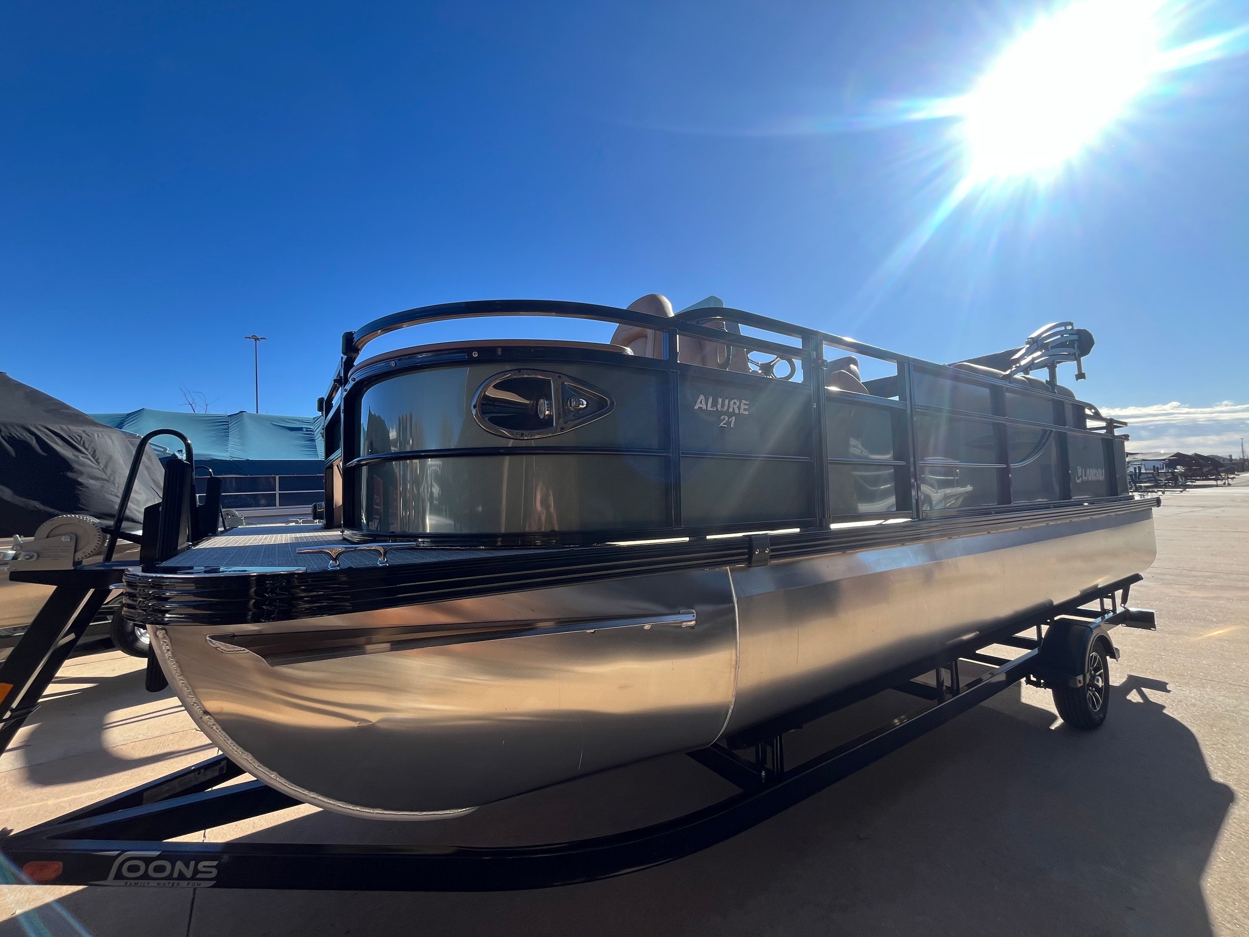 2026 Landau Alure 21CC Fish pontoon boat in sunlight.