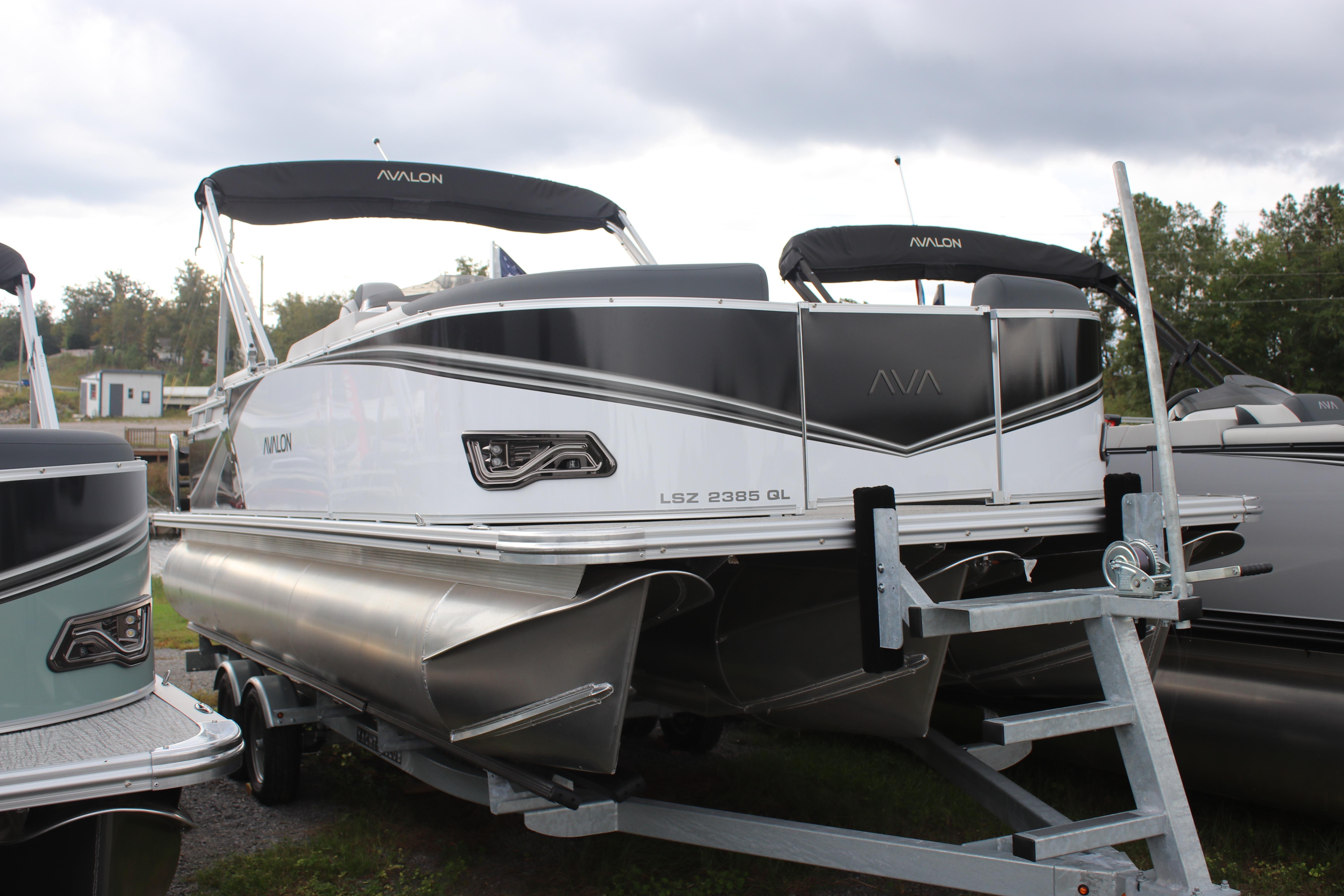 2025 Avalon LSZ Quad Lounger pontoon boat on trailer, showcasing sleek design and modern features.