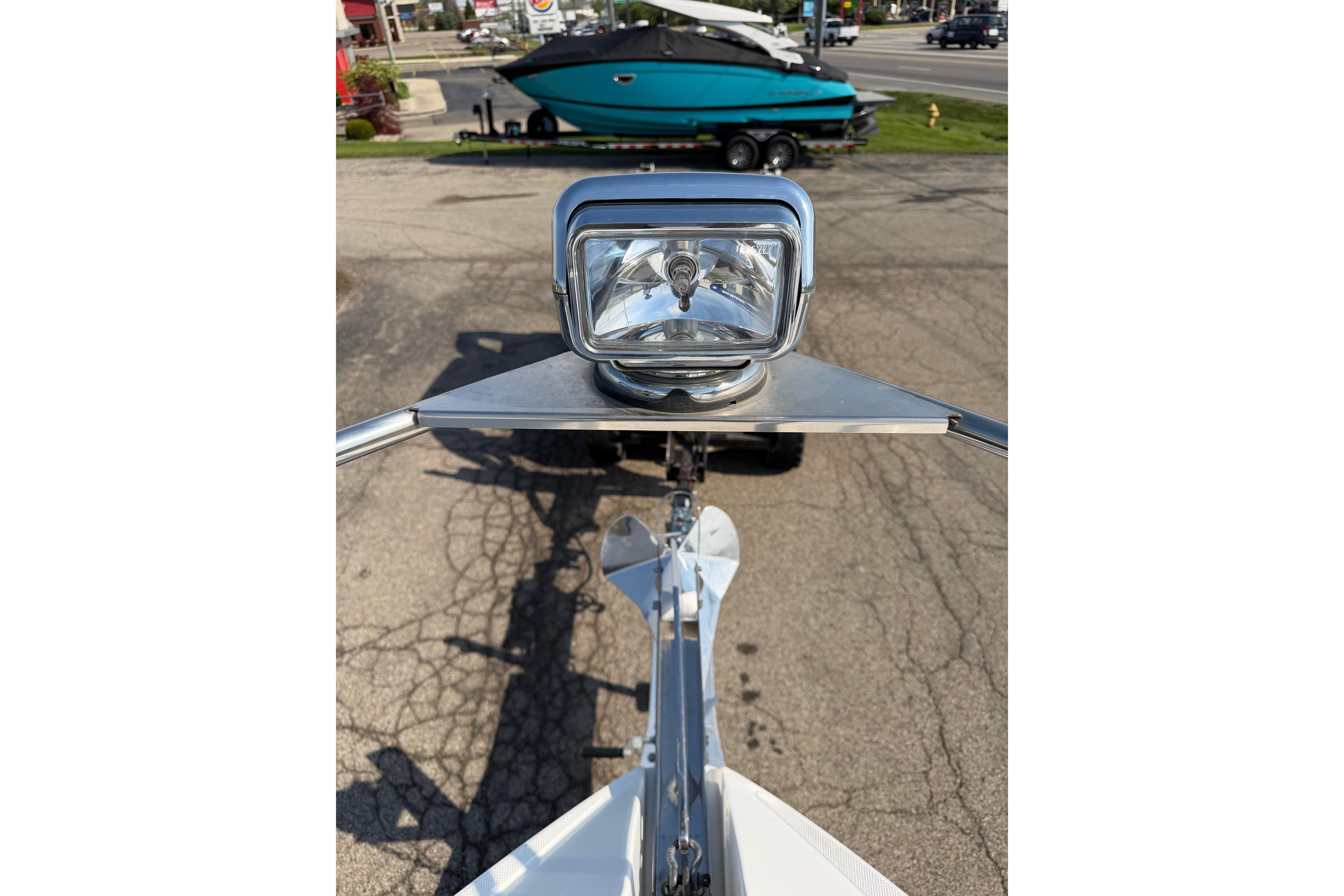 2019 Rinker EX 320 boat spotlight and trailer on a sunny day.