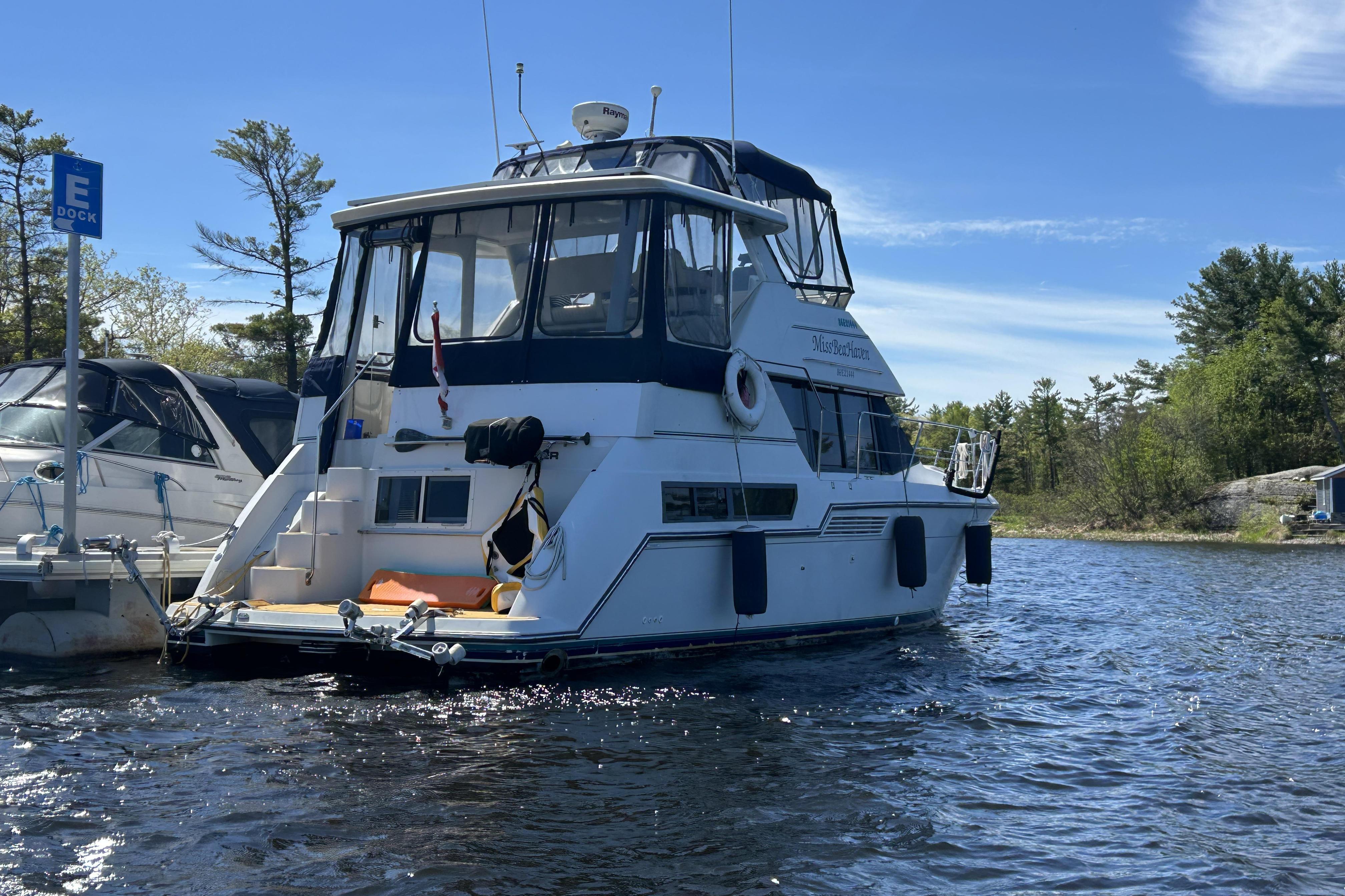 1995 Carver 355 Aft Cabin Motor Yacht docked on a sunny day.