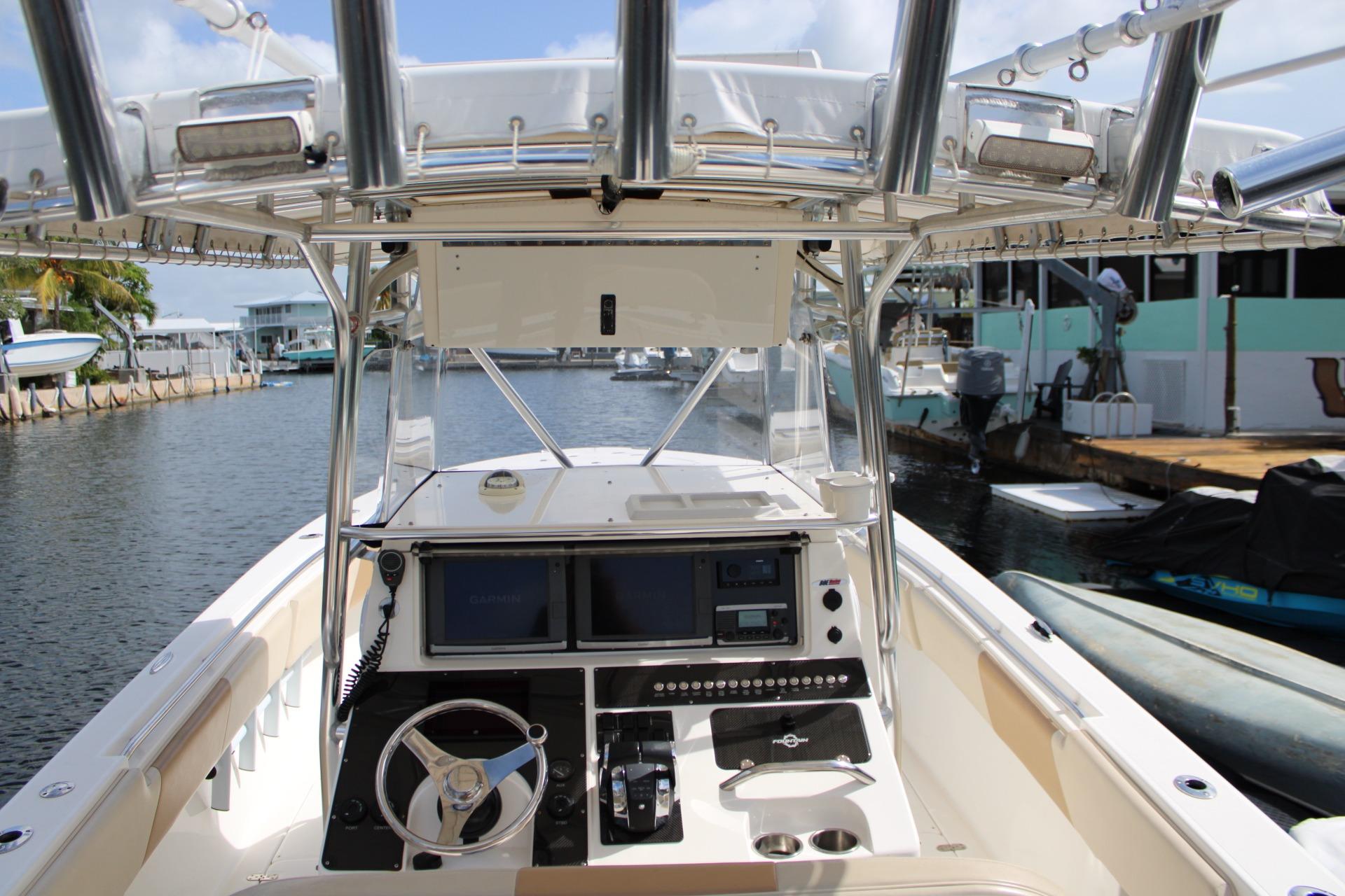 2007 Fountain 34 Center Console boat interior with steering wheel and navigation equipment.
