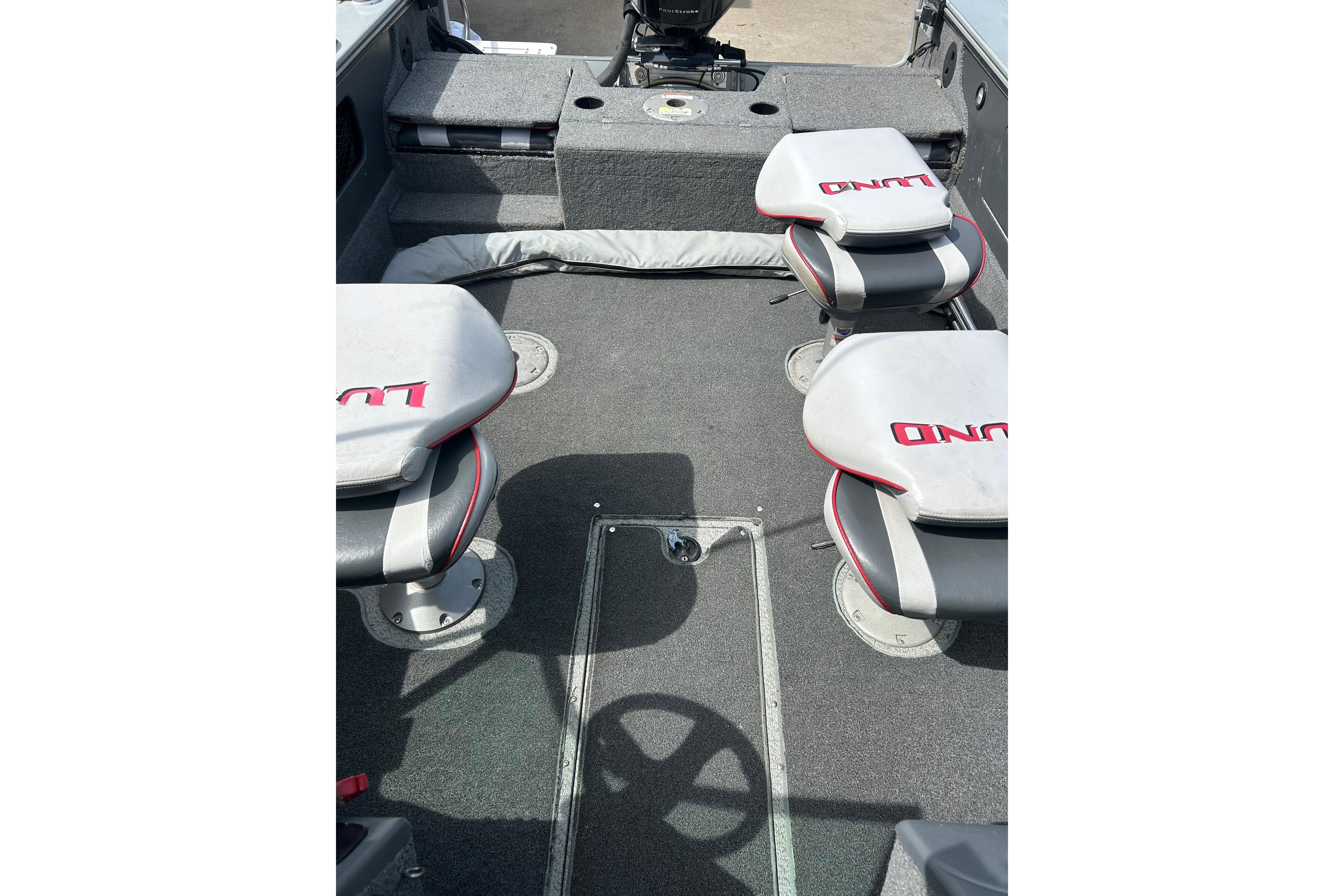 2008 Lund 1850 Fisherman boat interior with seating and steering wheel.