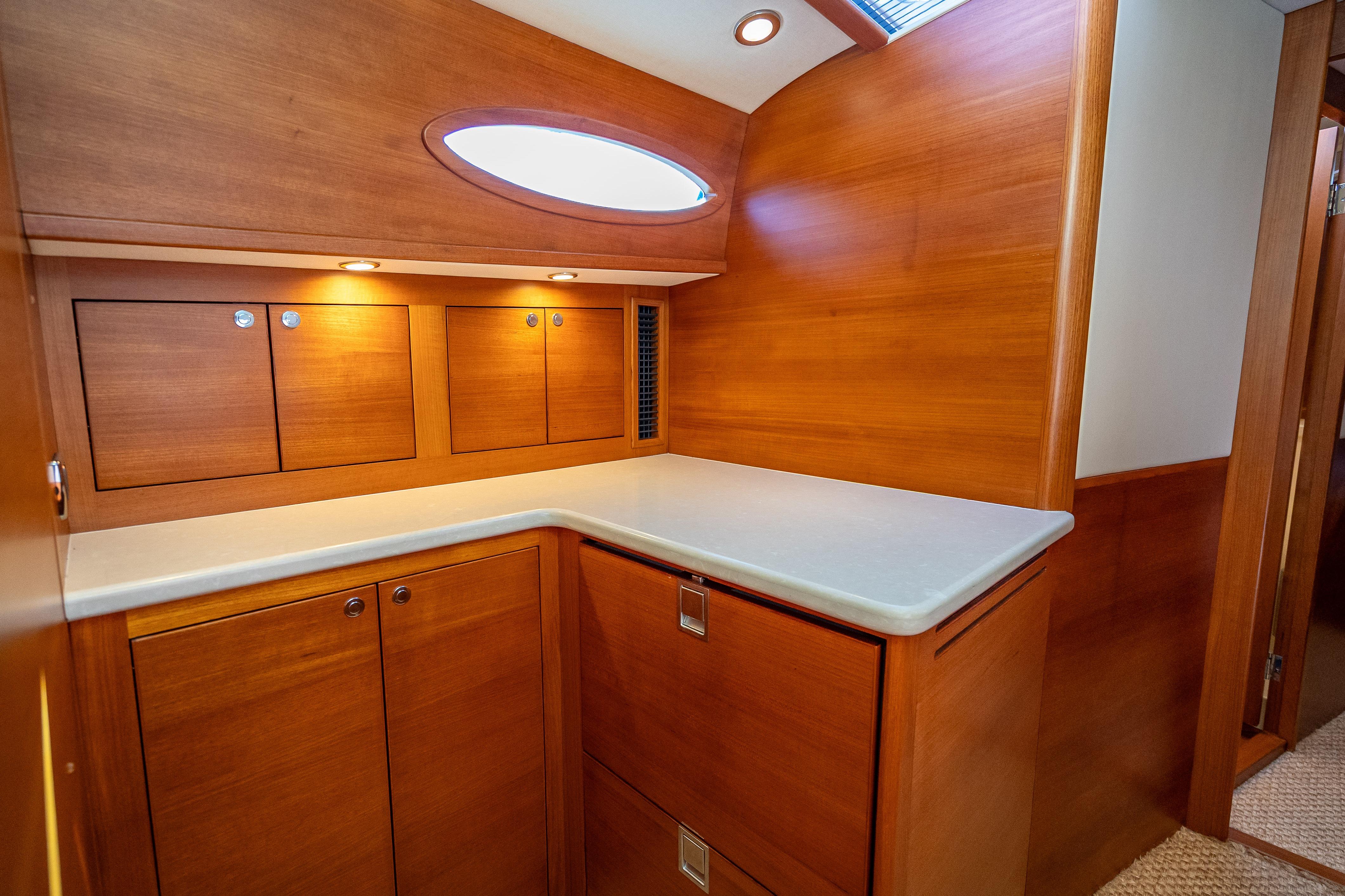 Luxurious wooden interior of 2018 Palm Beach Motor Yachts PB55, featuring elegant cabinetry and lighting.