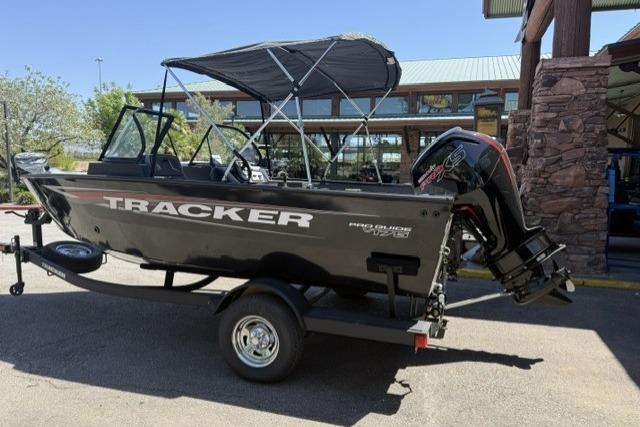 2026 Tracker Pro Guide V-175 WT boat on trailer, parked outdoors.