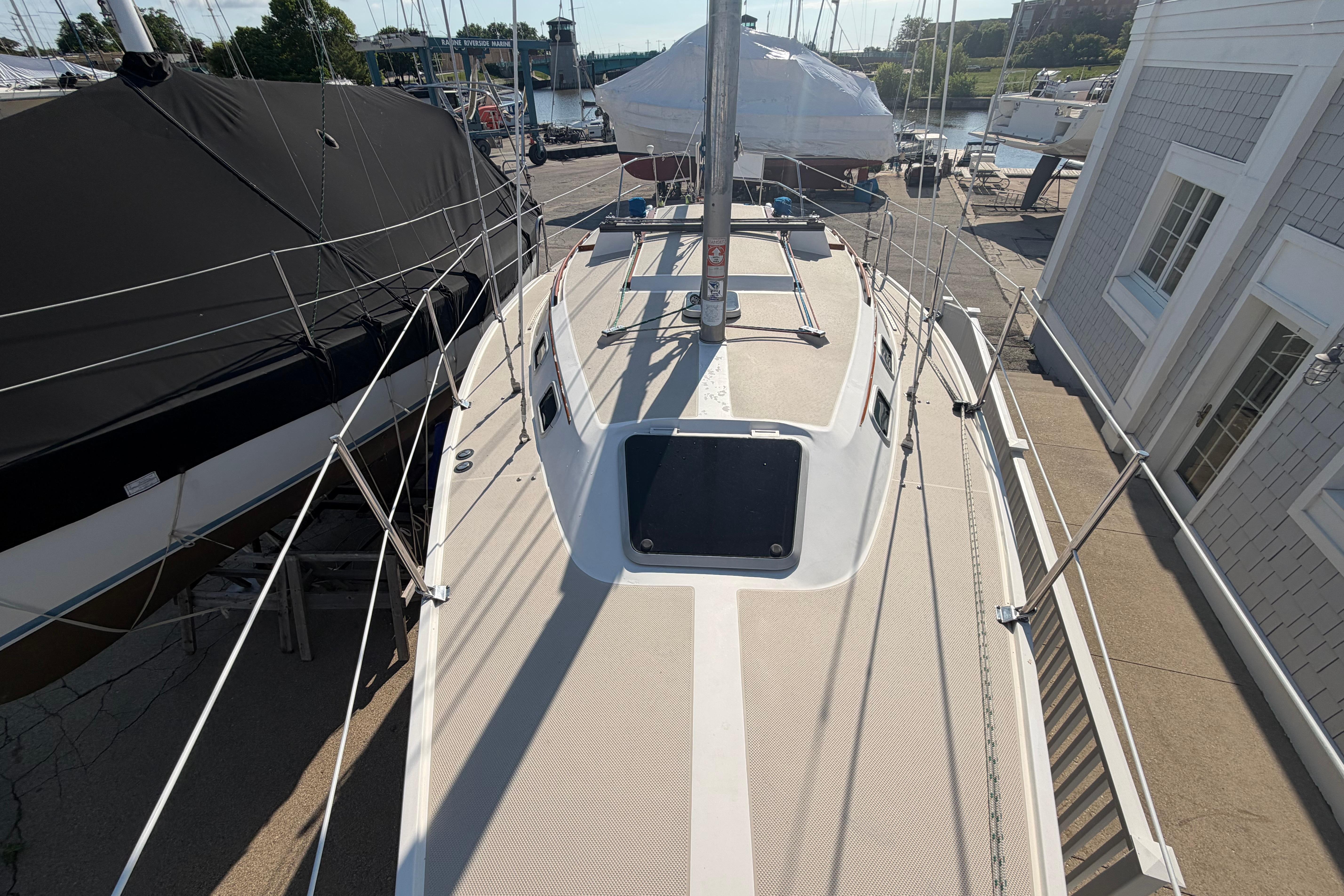 1988 Catalina 30 MkII sailboat docked, showcasing deck and rigging in a marina setting.