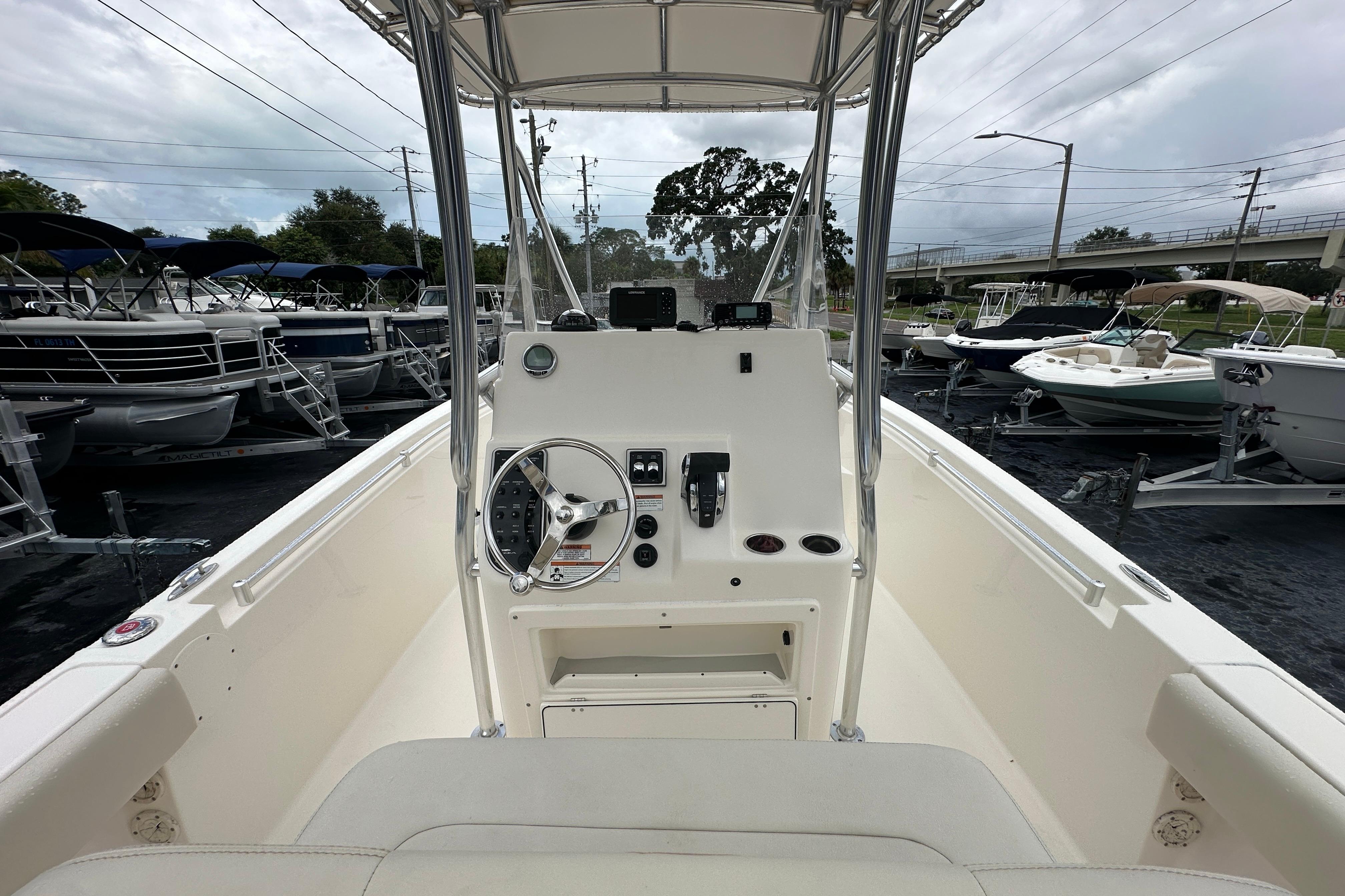 2022 Cobia 237 Center Console boat interior with steering wheel and controls.