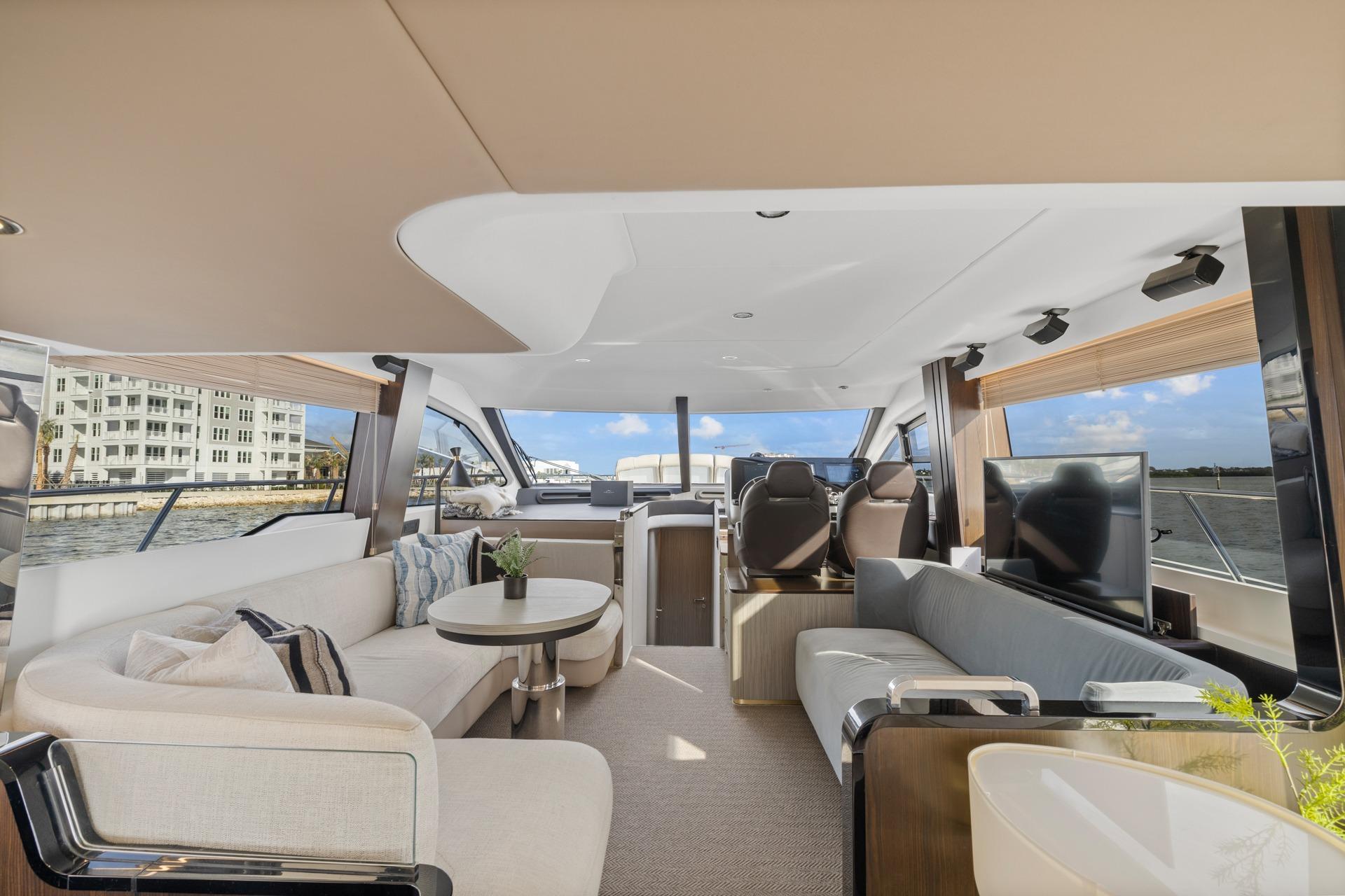 Luxurious interior of 2019 Azimut 55 yacht with modern furnishings and panoramic windows.