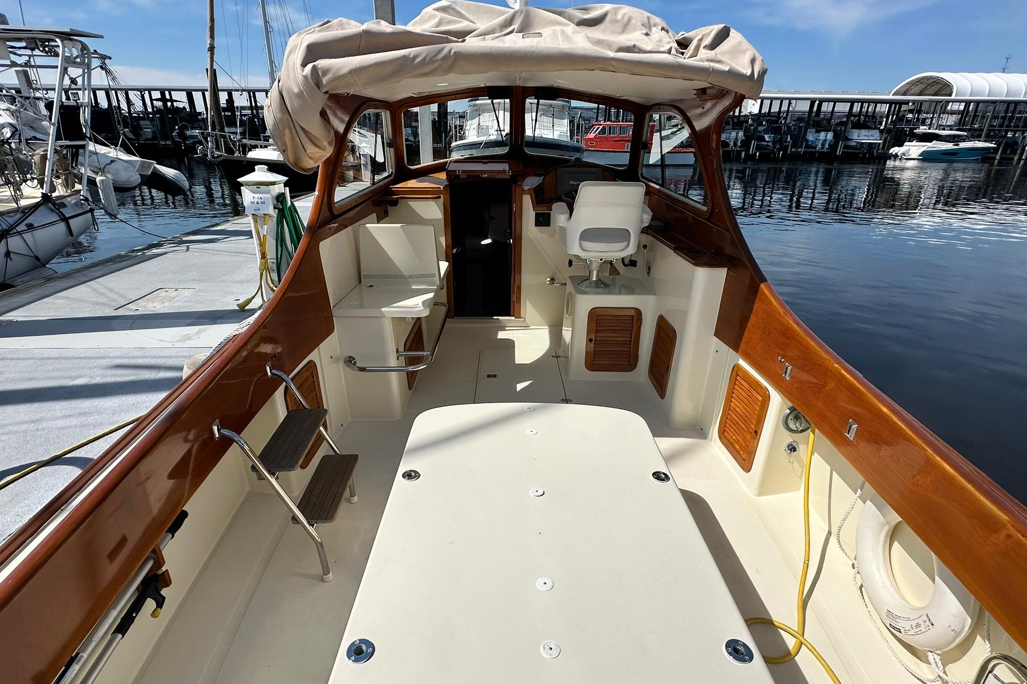 Hinckley Picnic Boat 36, 2000 model, docked with elegant wooden interior and spacious deck.