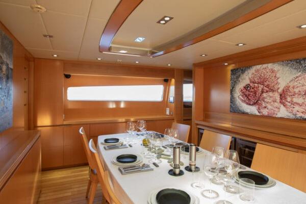 Luxurious dining area on 2009 Maiora 31DP yacht with elegant table setting.