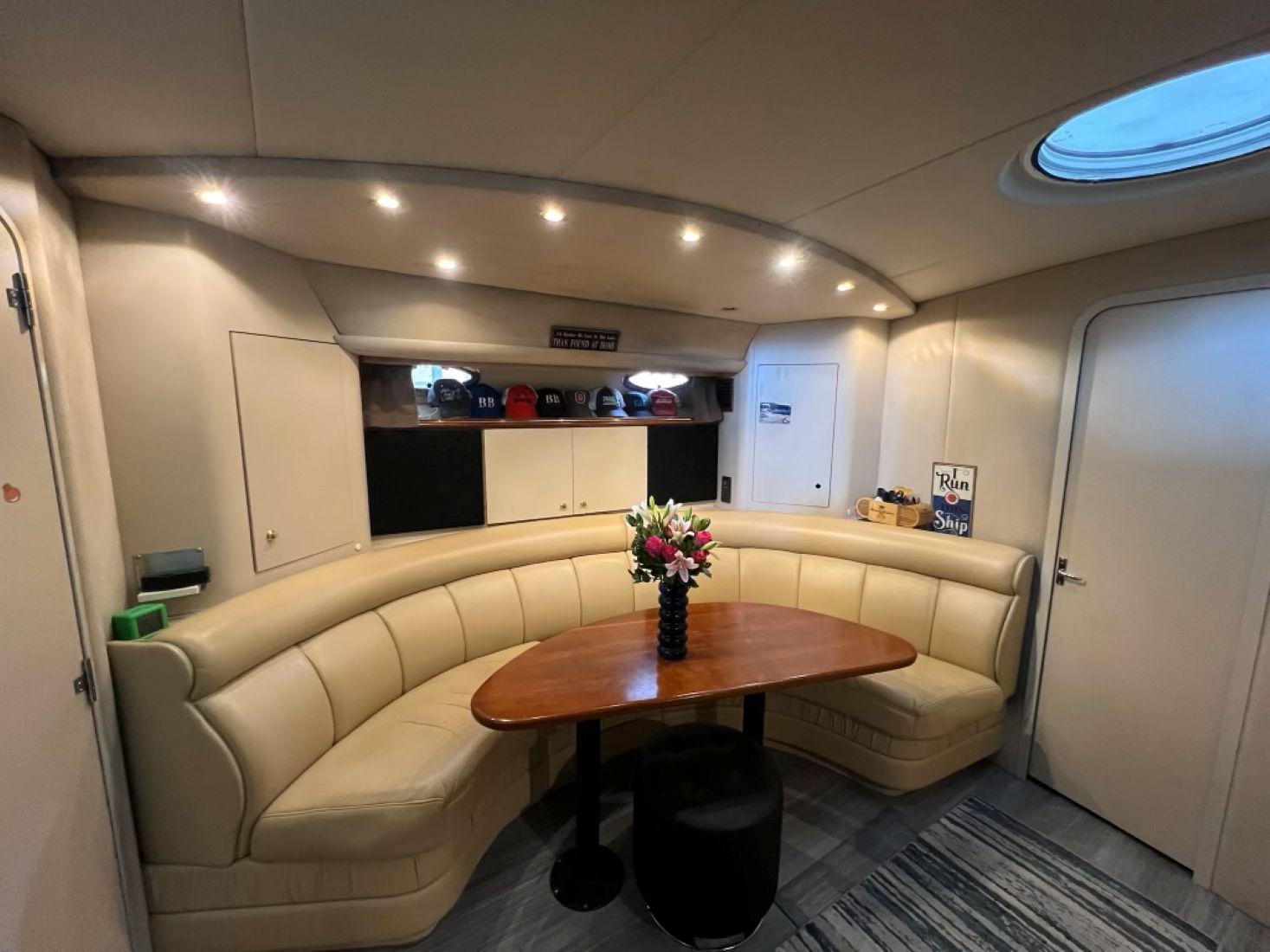 Luxurious interior of 2000 Cruisers Yachts 4270 Express with elegant seating and table.