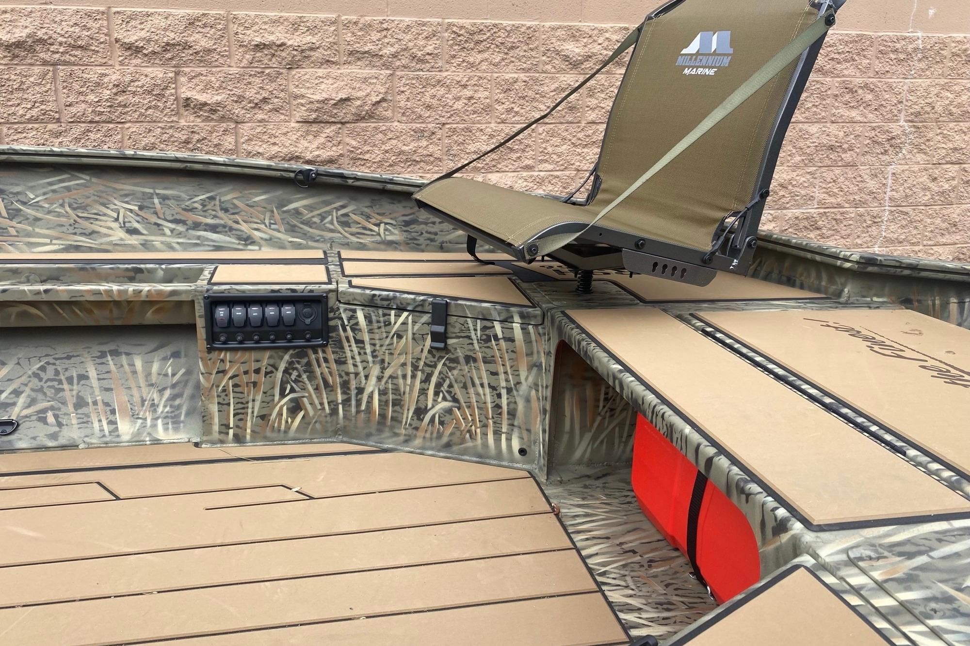 2026 Tracker Grizzly 1756 T Marsh boat interior with camo design and seating.