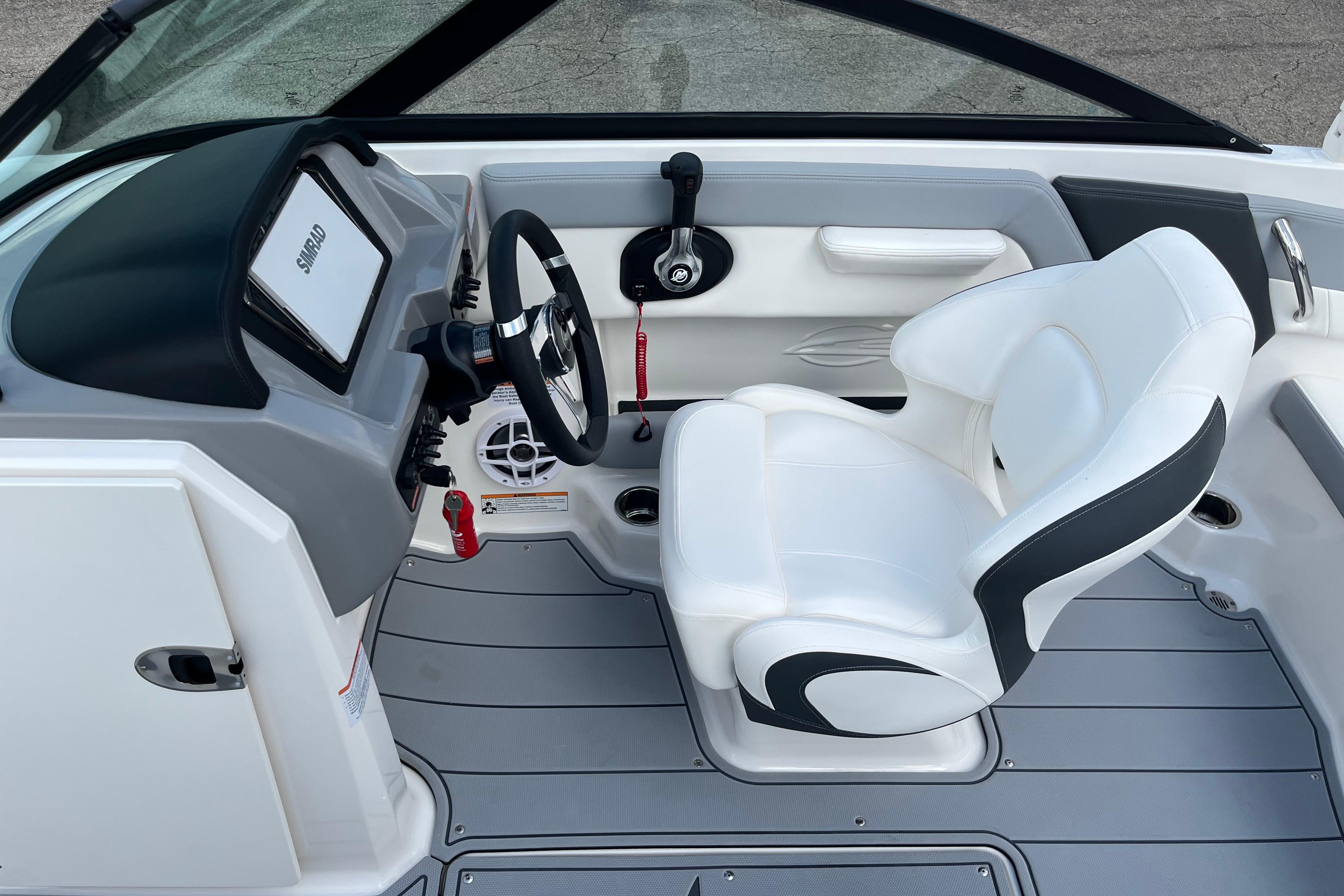 2026 Chaparral 21 SSi boat interior with white captain's seat and modern dashboard.