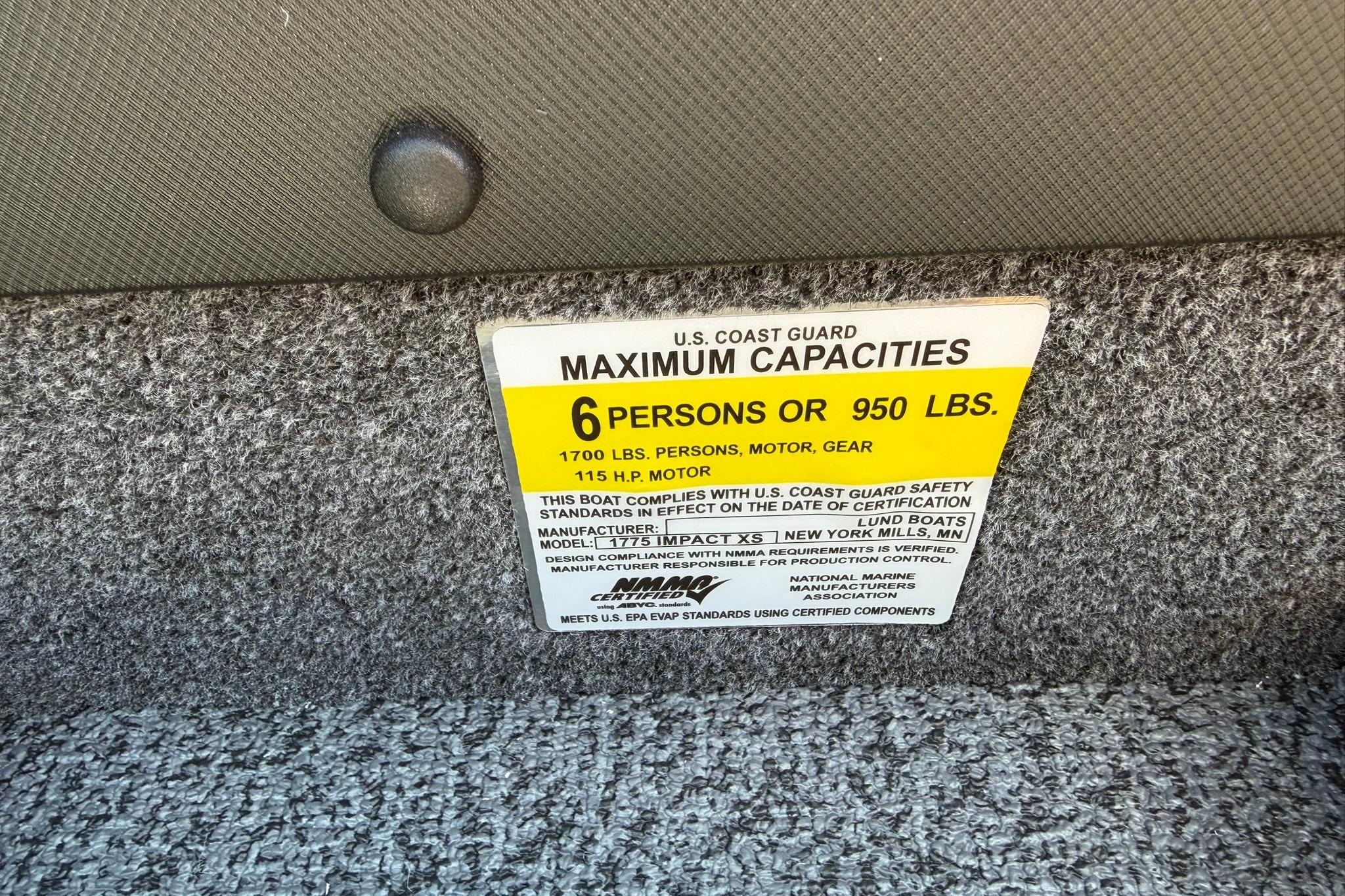Capacity label on 2027 Lund 1775 Impact XS Sport boat, max 6 persons or 950 lbs.