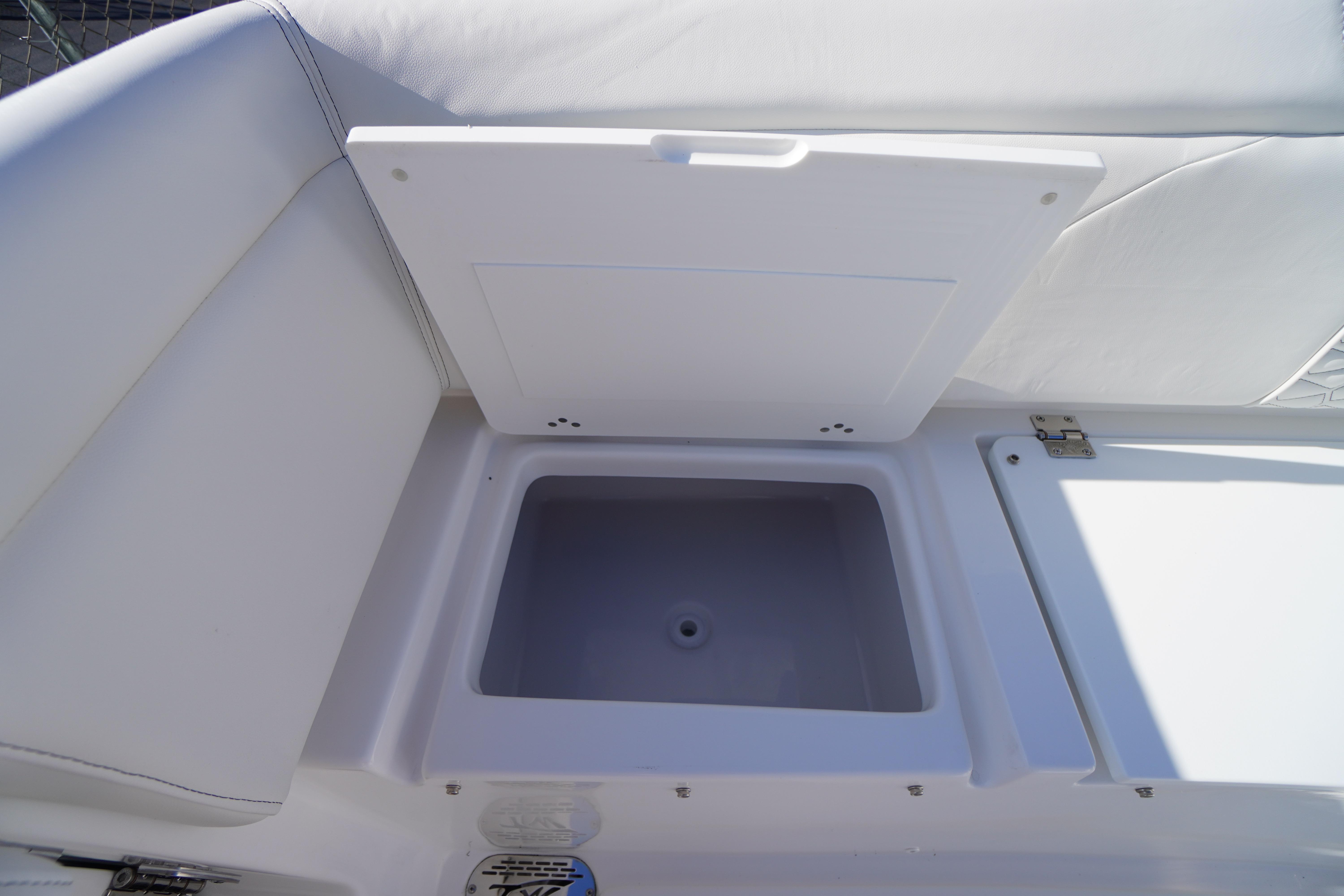 2026 Tidewater 272 LXF boat storage compartment with open lid, showcasing interior space.