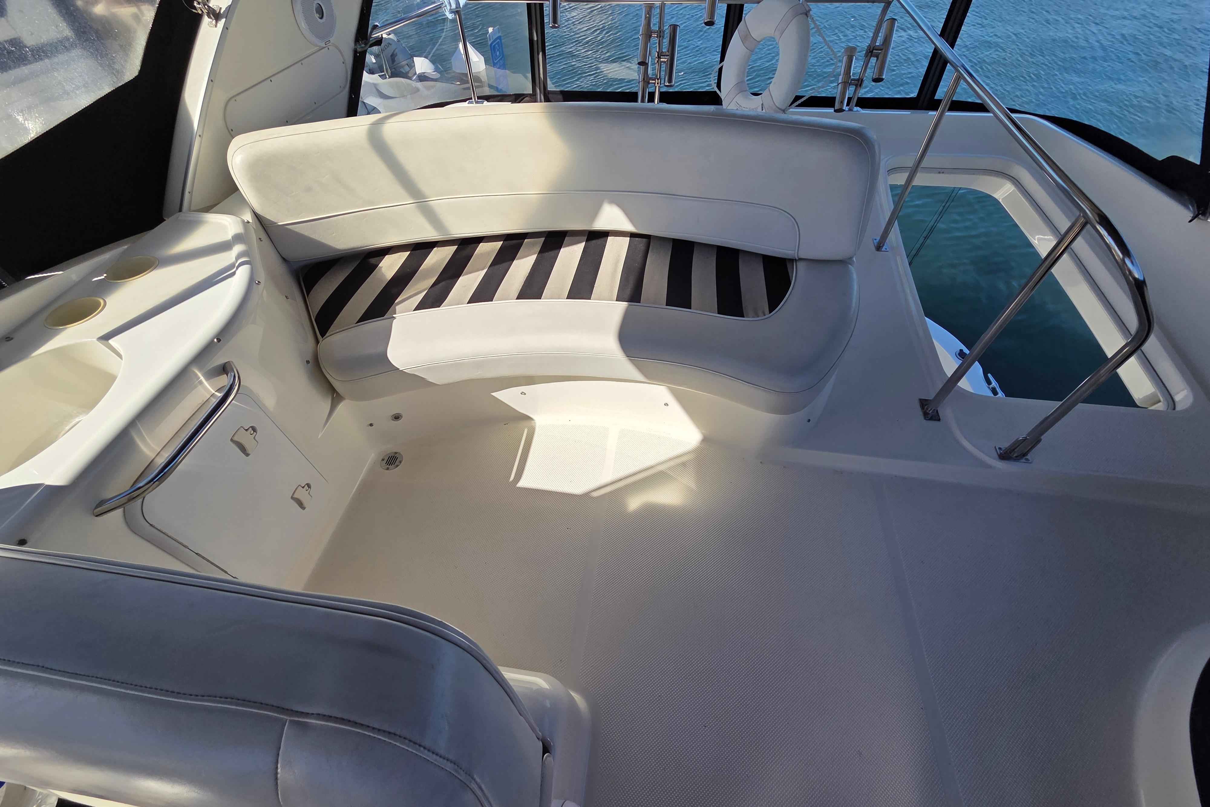 2005 Meridian 411 Sedan interior with white seating and striped cushions.