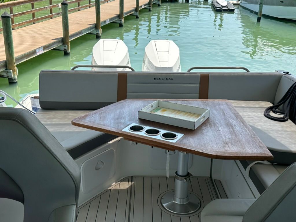 Interior of 2024 Beneteau Gran Turismo 32 with wooden table and seating area.