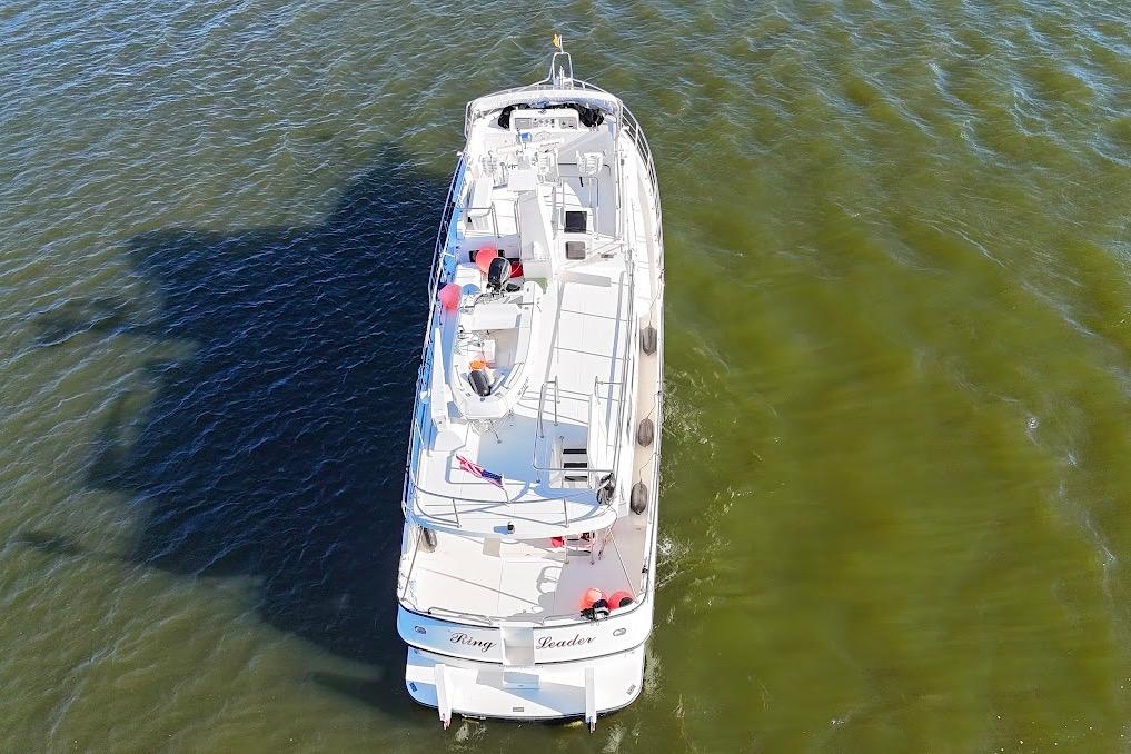 Nordic Tug 54 (2007) cruising on calm green waters, aerial view.
