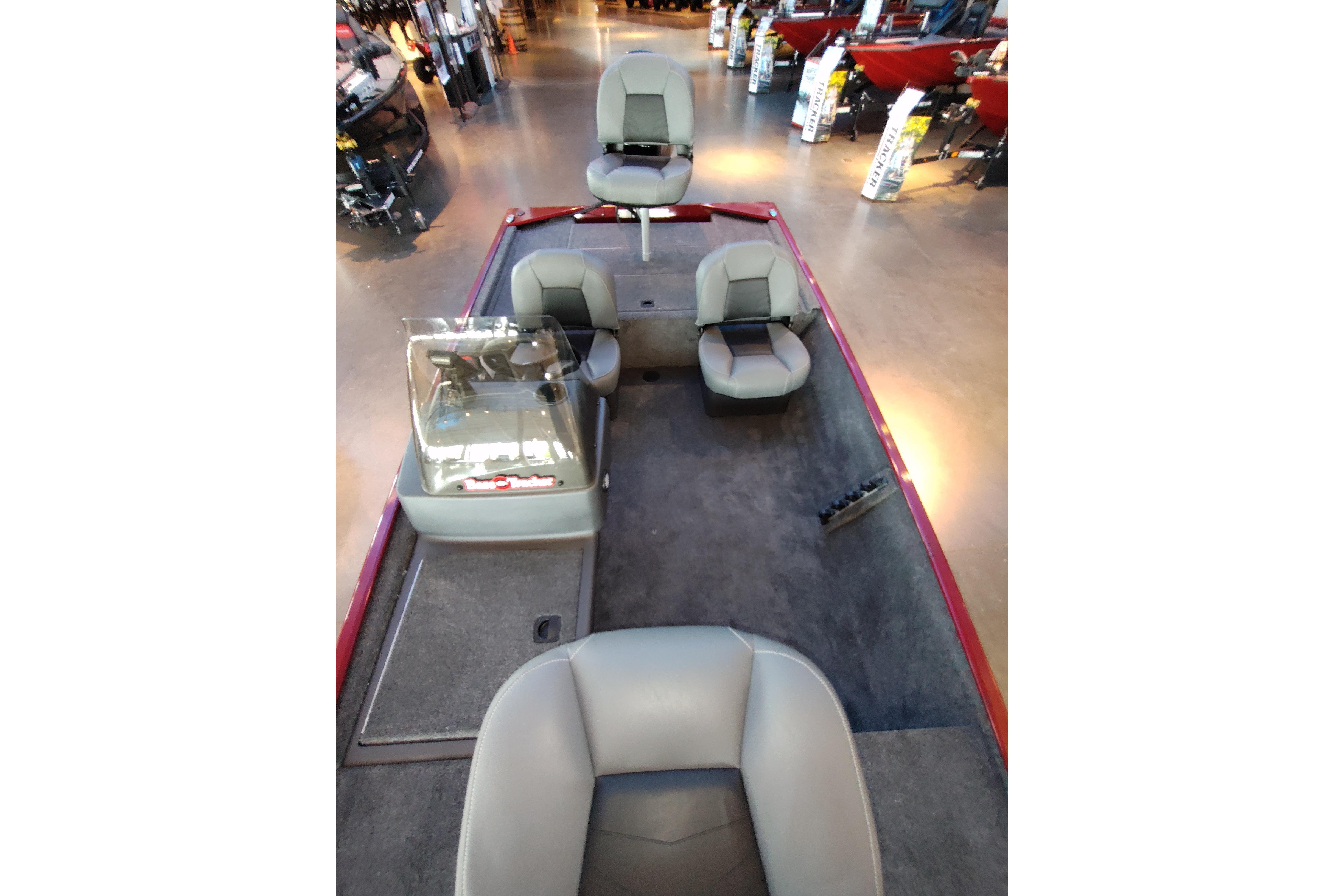 2026 Tracker Bass Tracker Classic XL boat interior with seating and console, displayed in showroom.