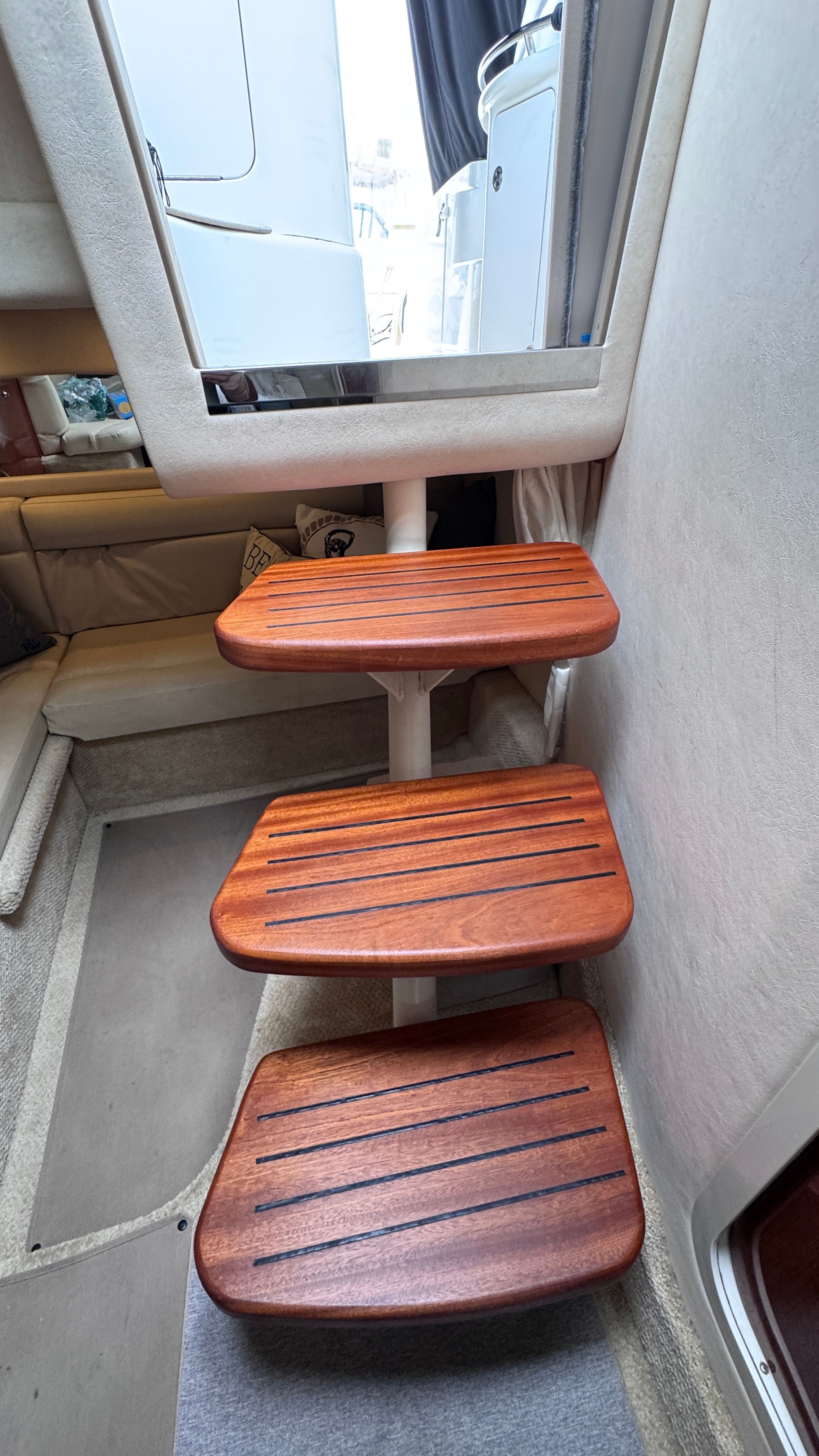Wooden steps inside the cabin of a 2003 Sea Ray 360 Sundancer.