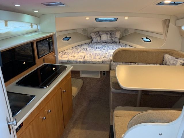 Interior of a 2002 Bayliner 2855 yacht with kitchen and sleeping area.