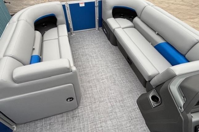 2026 Sun Tracker Party Barge 20 DLX interior with gray and blue seating.
