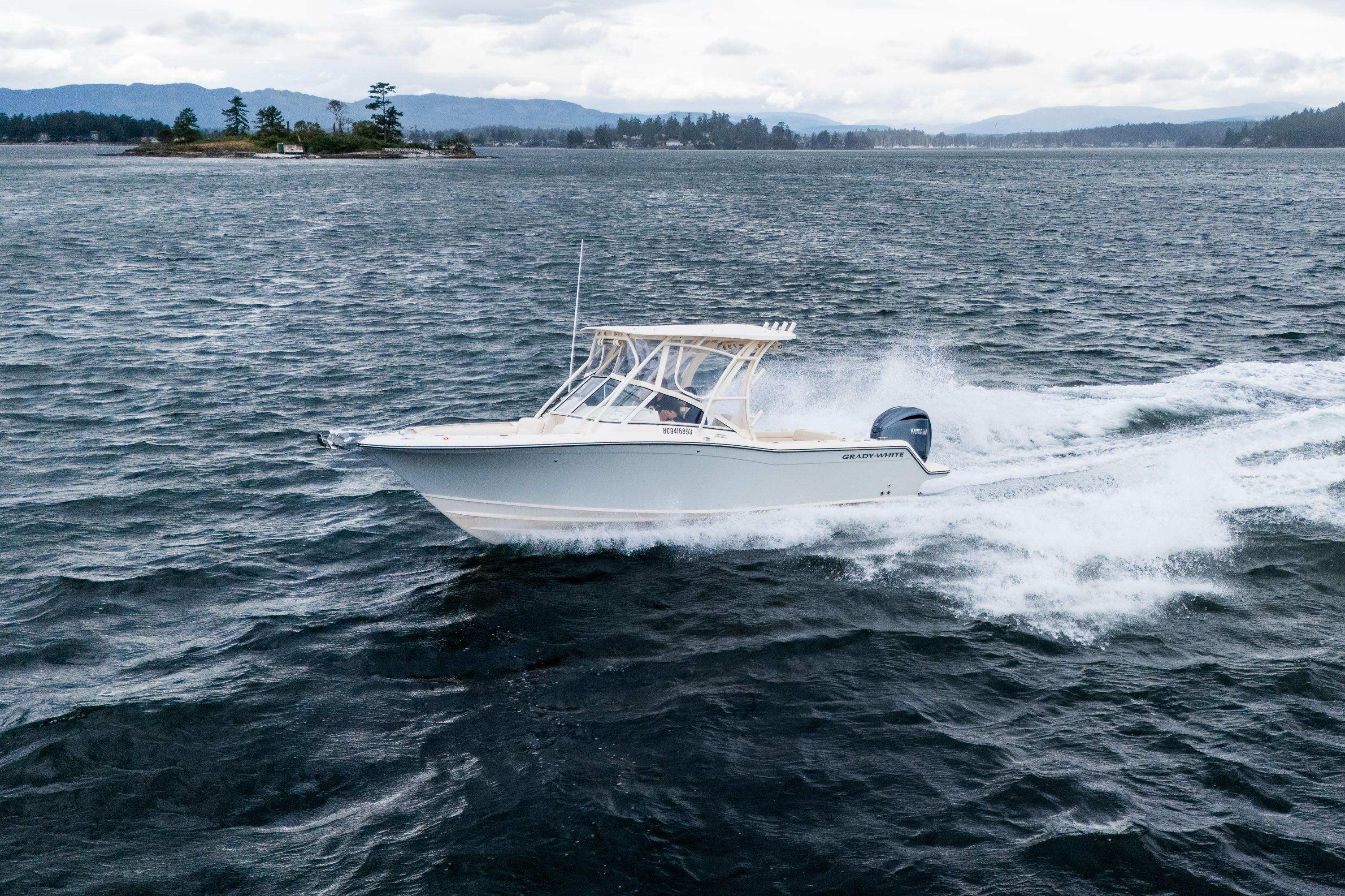2023 Grady-White Freedom 235 boat cruising on open water, showcasing sleek design and performance.