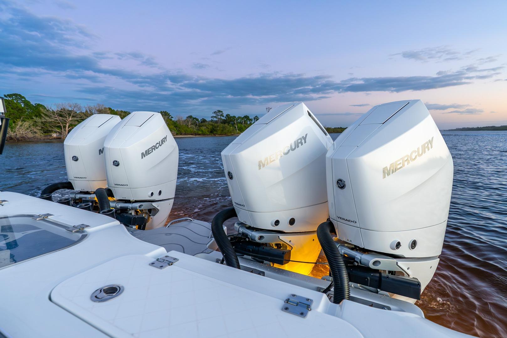 2025 Freeman 43 boat with four Mercury Verado outboard engines on a calm water backdrop.