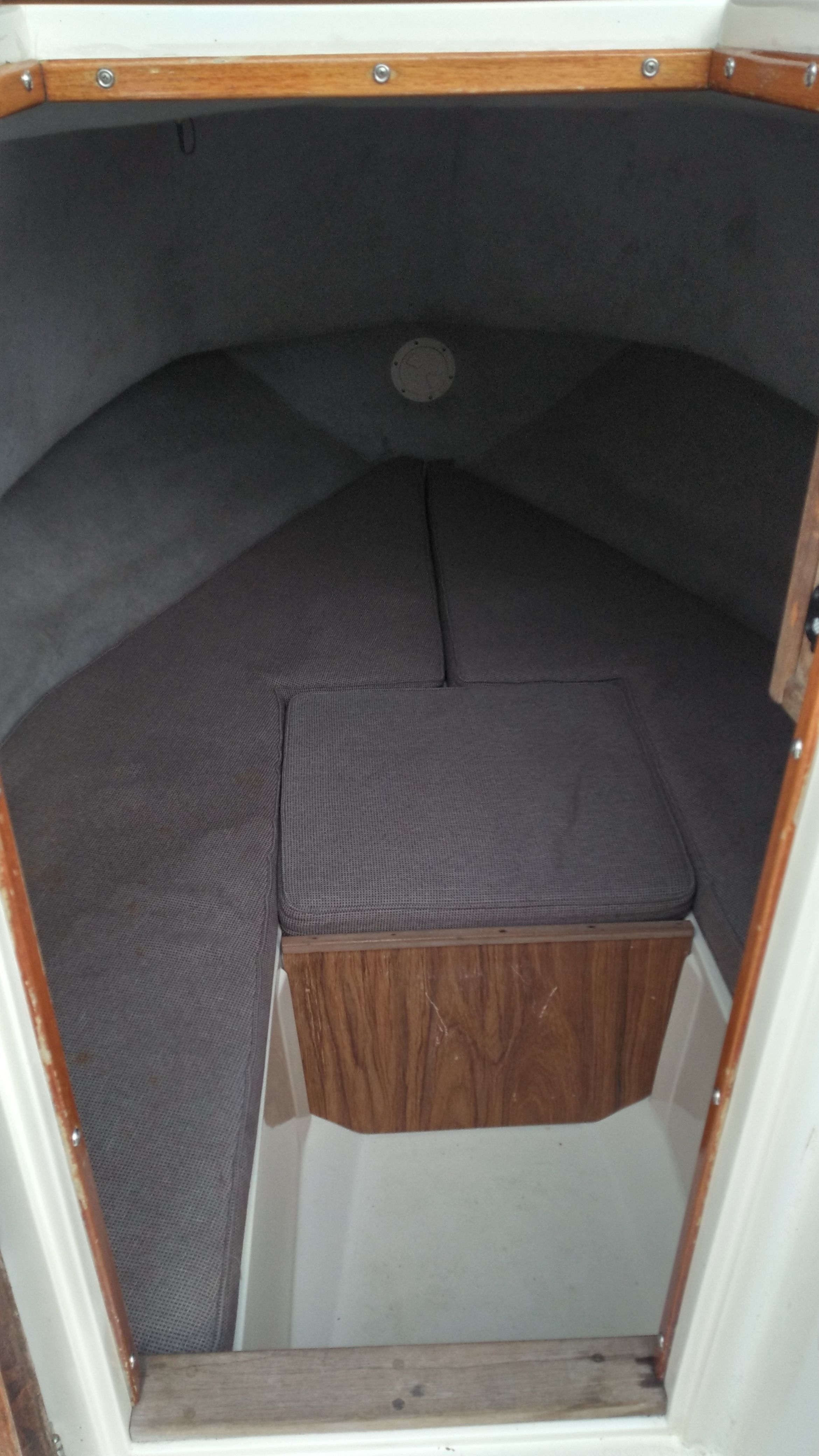 Interior of a 1989 Mako 240 Walk Around with cushioned seating.
