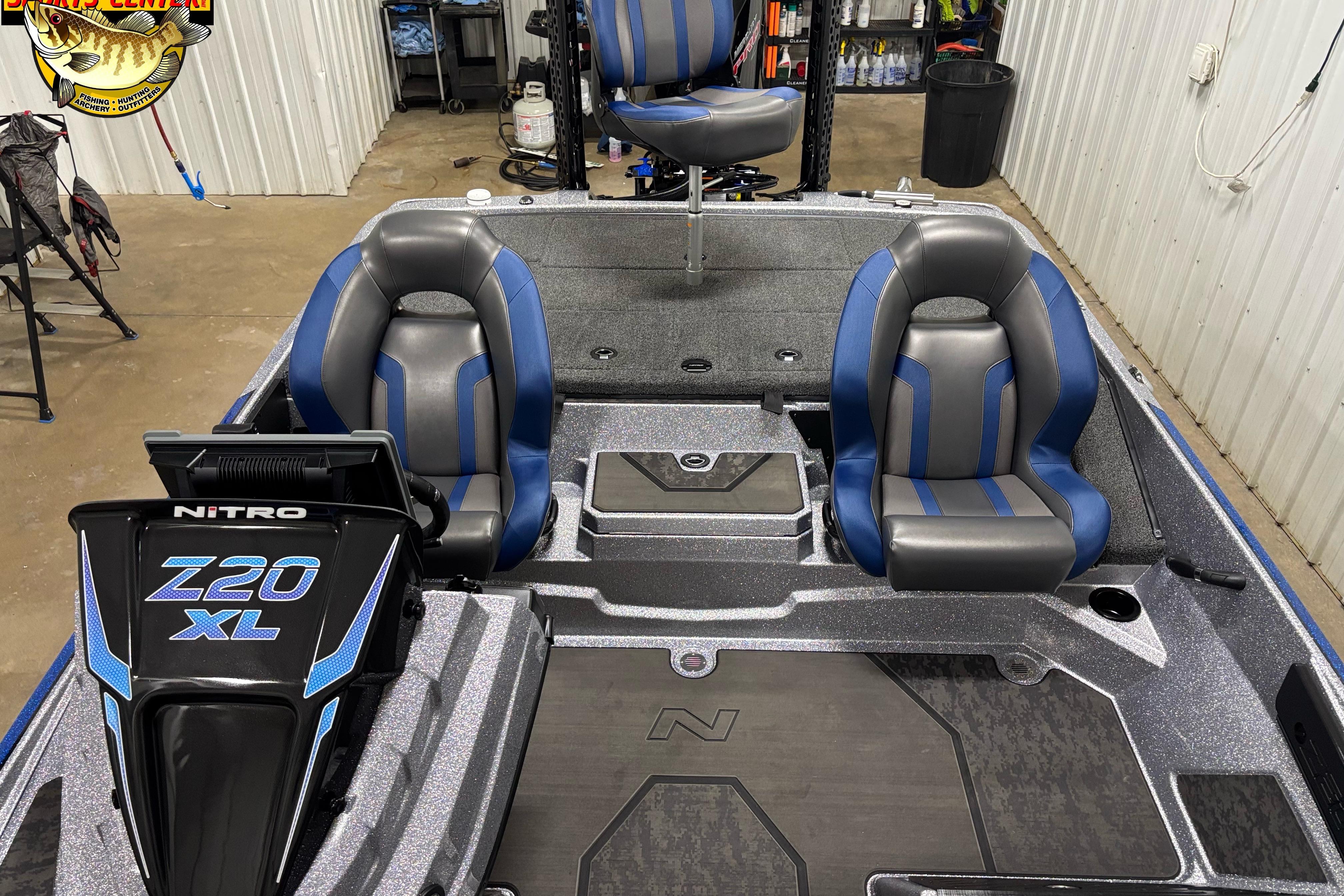 2026 Nitro Z20 XL boat interior with blue and gray seats in a garage setting.