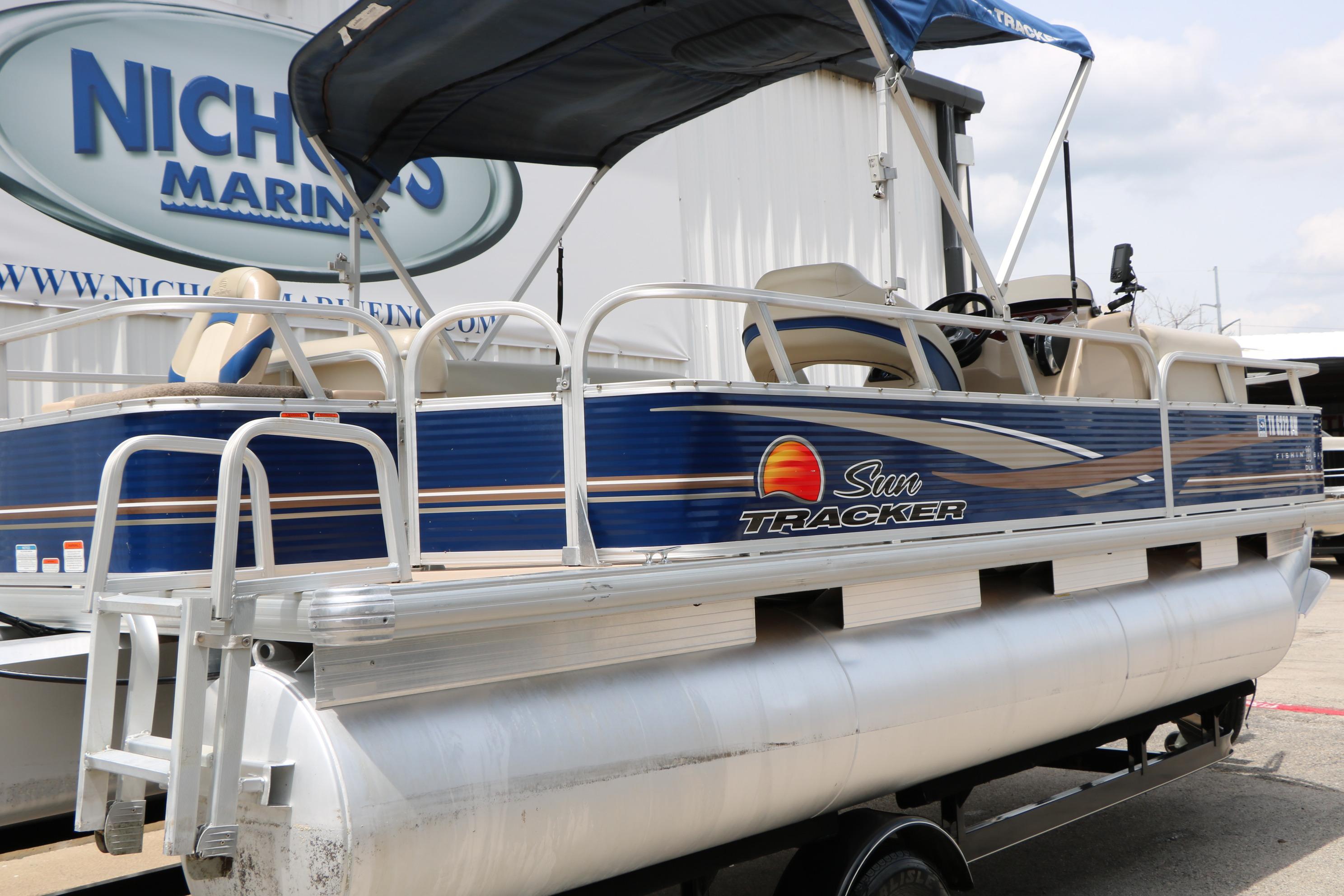 2013 Sun Tracker Fishin' Barge 20 DLX pontoon boat displayed at dealership.