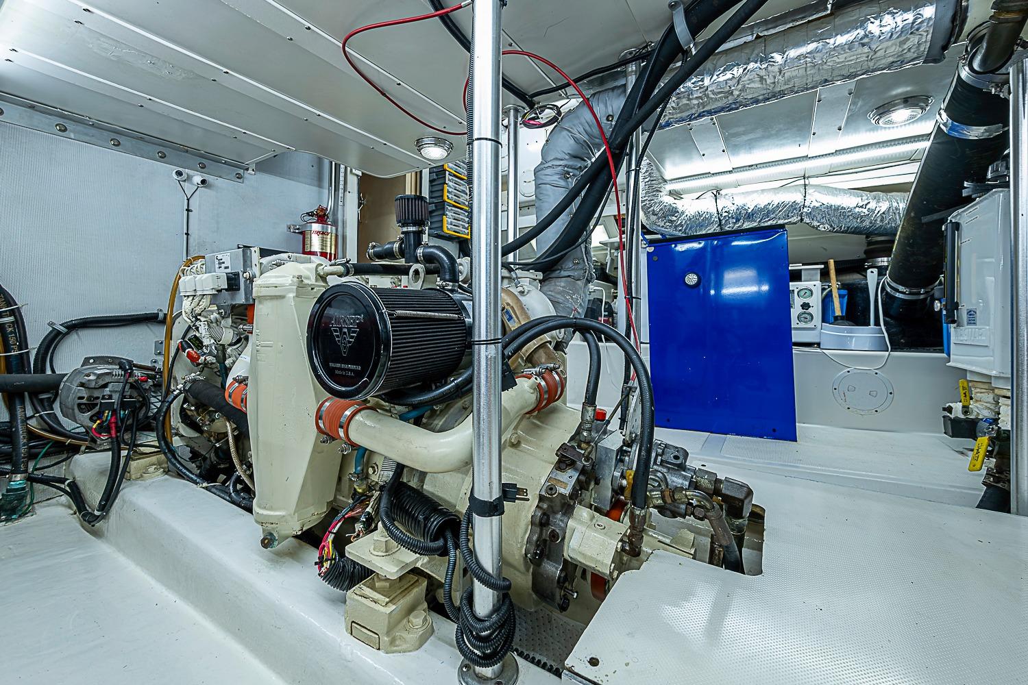 Engine room of 2003 Magna Marine Nova Scotia 47, showcasing mechanical components and wiring.
