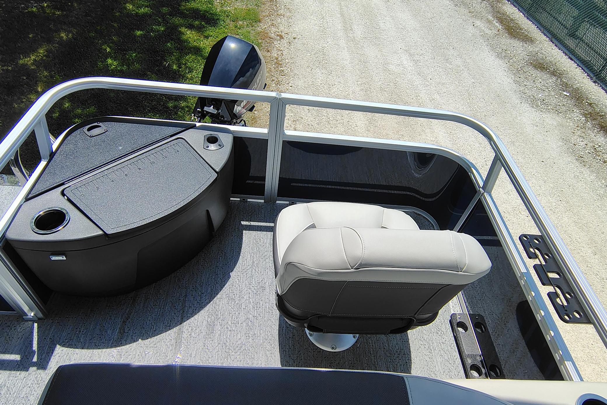 2026 Sun Tracker Bass Buggy 18 DLX pontoon boat interior with seating and motor view.