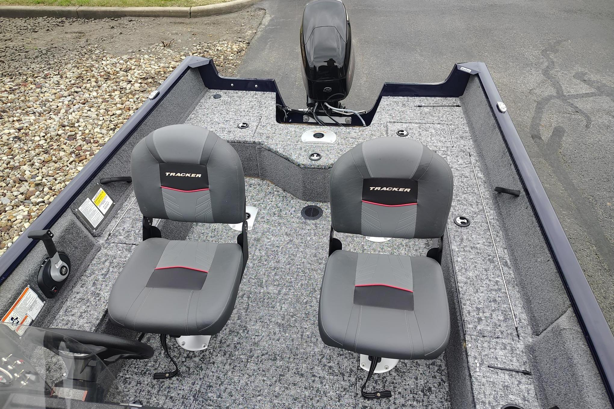 2026 Tracker Pro Guide V-16 SC boat interior with two gray seats and motor.