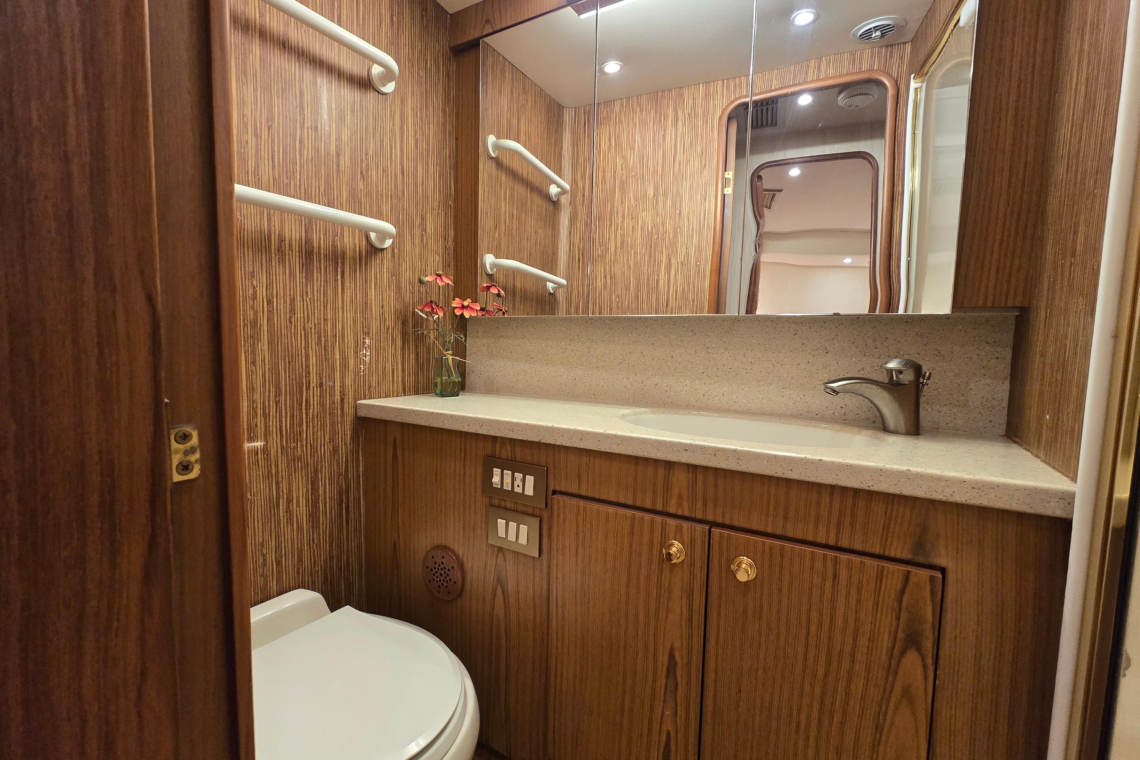 Luxurious bathroom in 2007 Ocean Yachts 46 Super Sport with wood finish and modern fixtures.