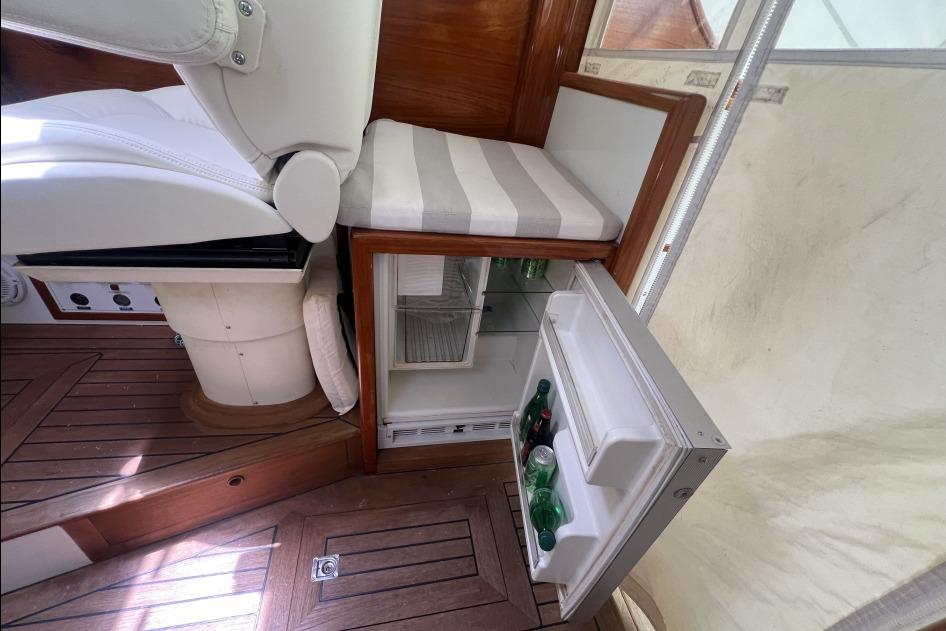 Interior of 2004 RB DERELI Daytripper 40 yacht with open mini fridge and seating.