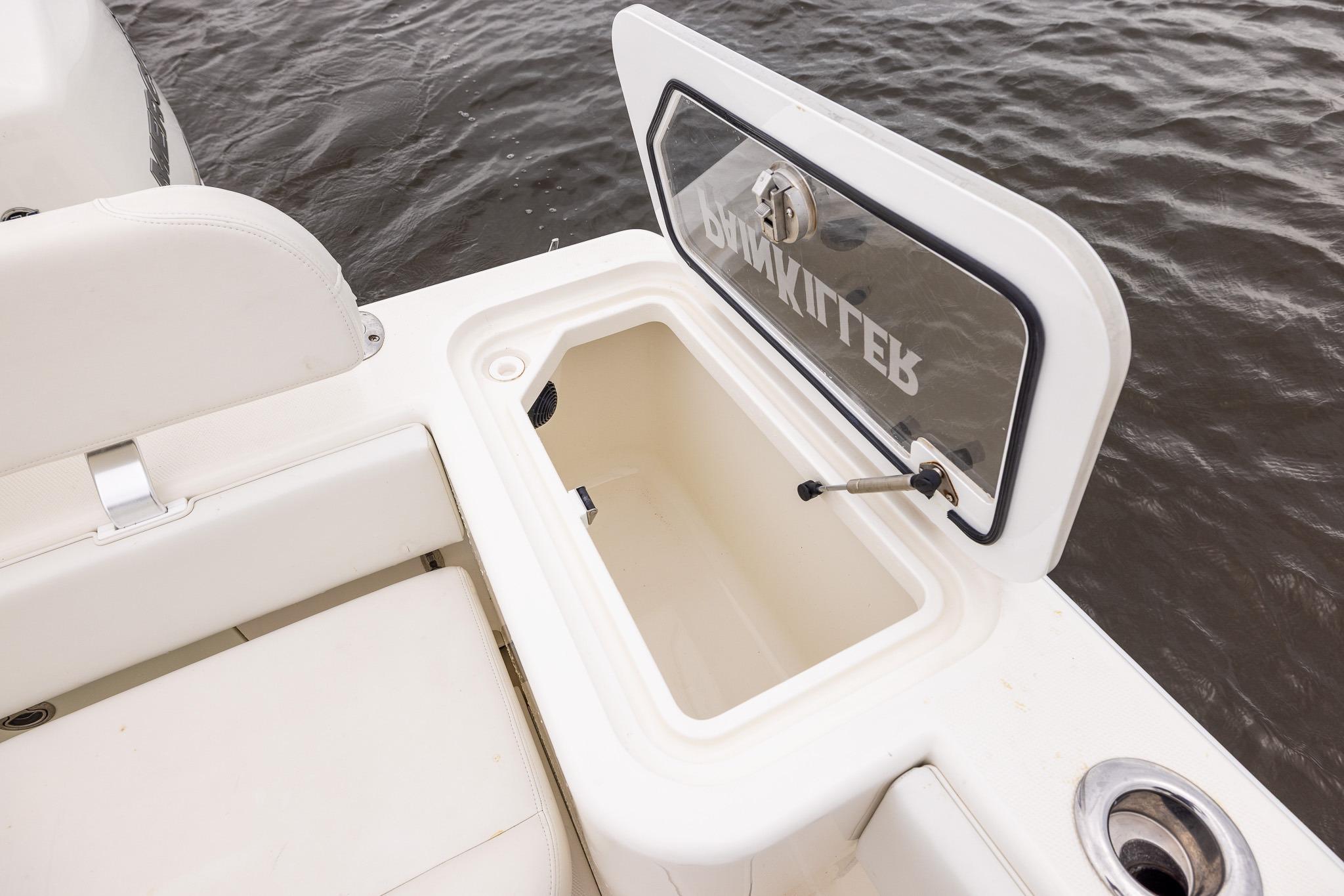 Open storage compartment on 2019 SeaVee 322Z boat, near water.