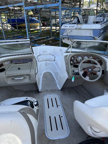 2005 Crownline 180 BR boat interior with steering wheel and dashboard in storage area.