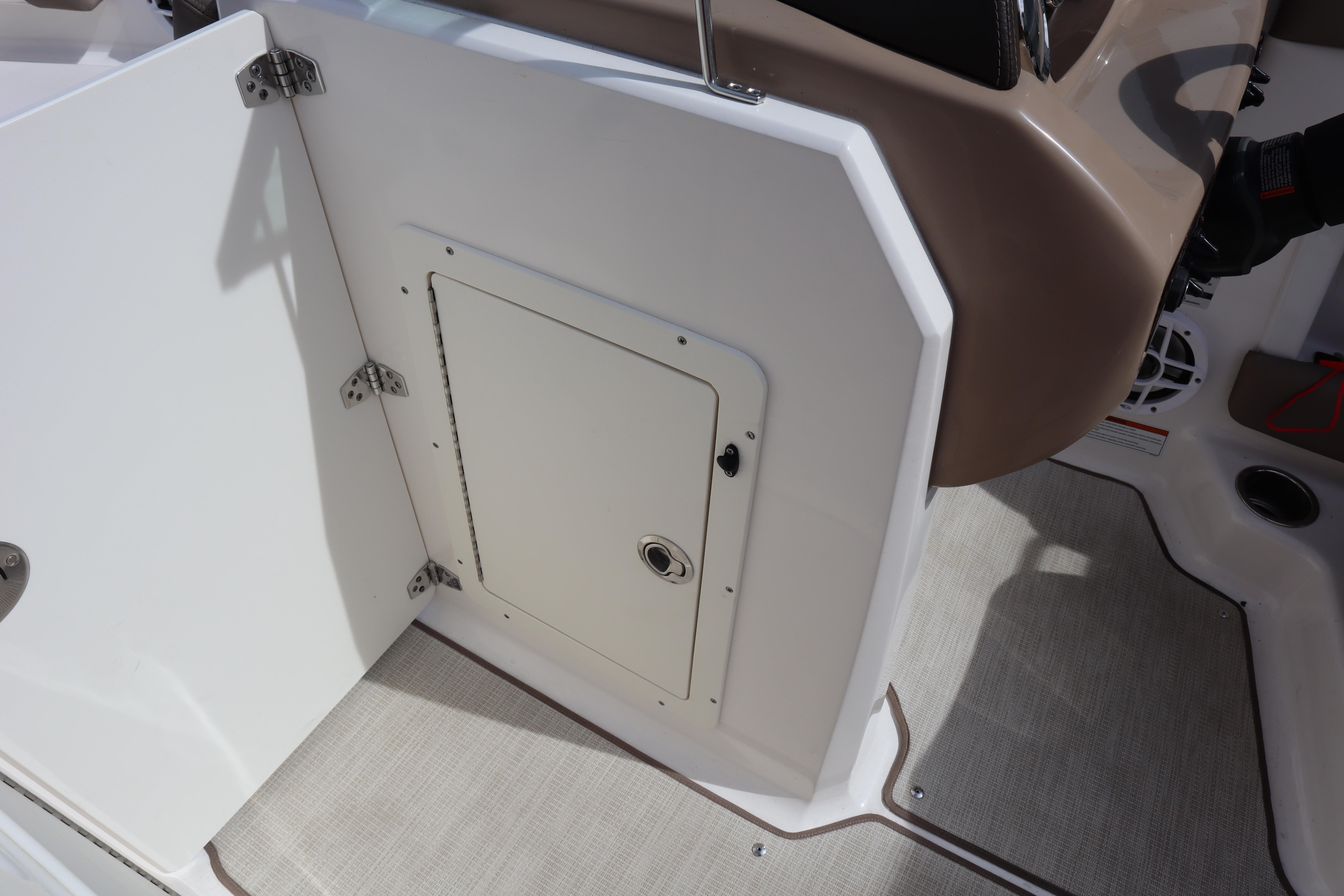 2021 Chaparral 21 SSi boat interior with storage compartment and beige accents.
