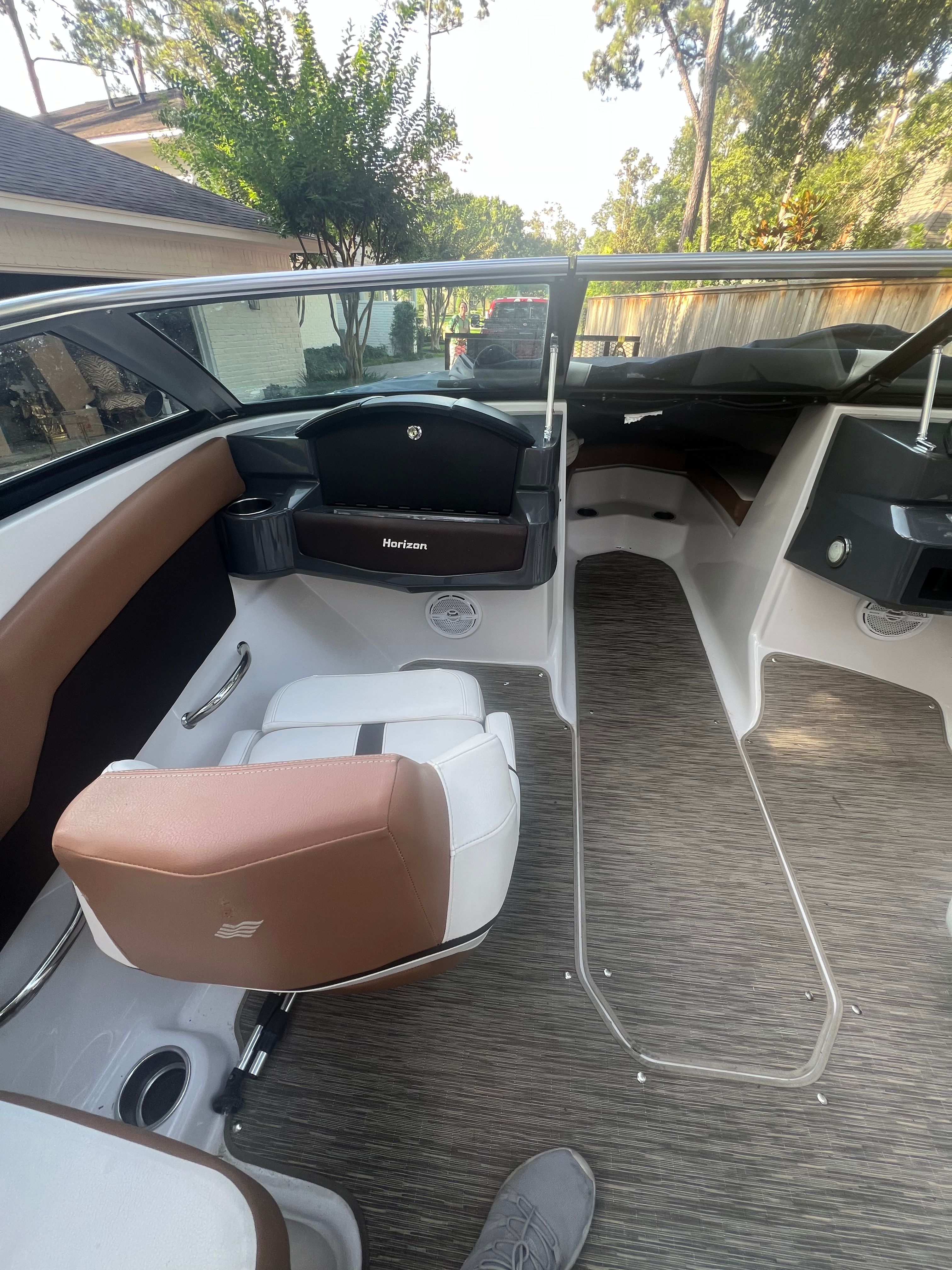Interior of a 2017 Four Winns H230 boat with brown seating.