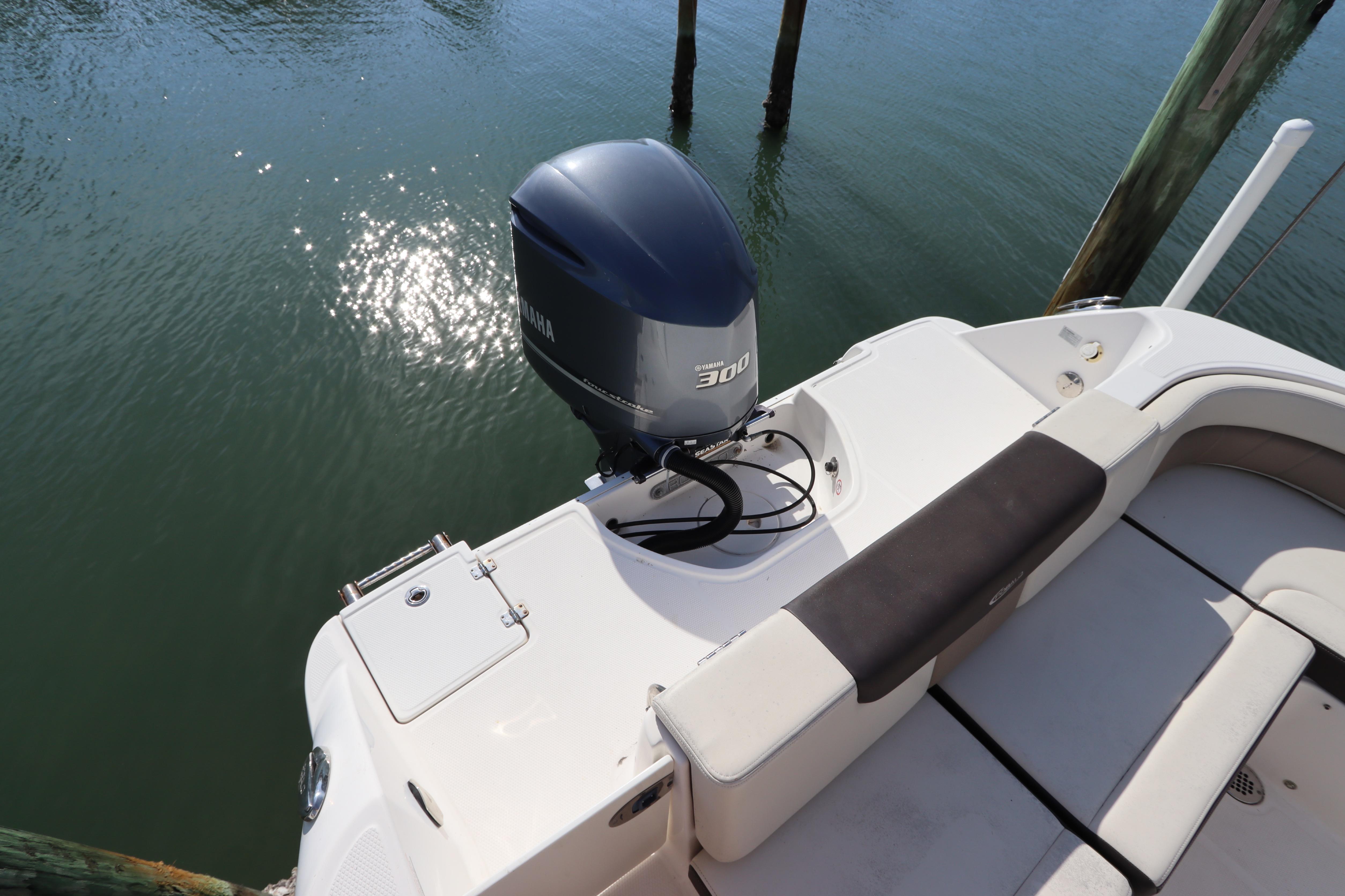 2019 Robalo R242 Center Console boat with Yamaha 300 engine, docked on calm water.