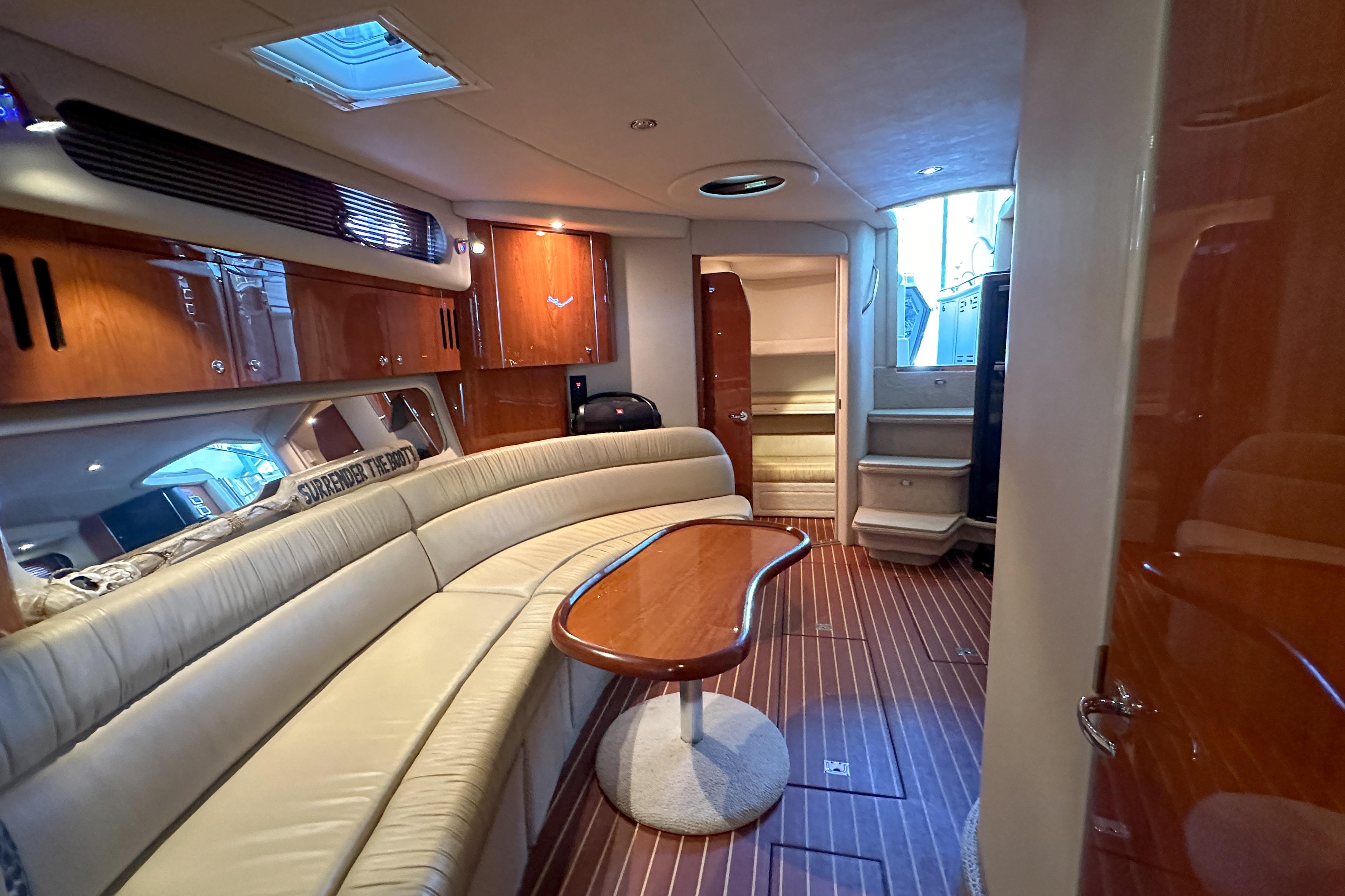 Luxurious interior of a 2001 Sea Ray 410 Sundancer yacht with elegant seating and wood finishes.