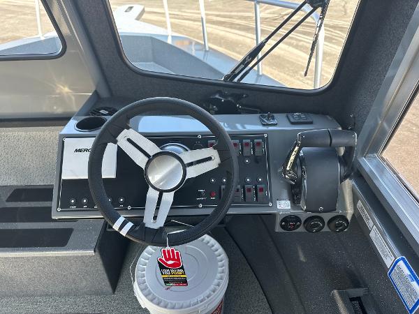 2024 Spartan 260 Maximus Pro XL boat cockpit with steering wheel and control panel.