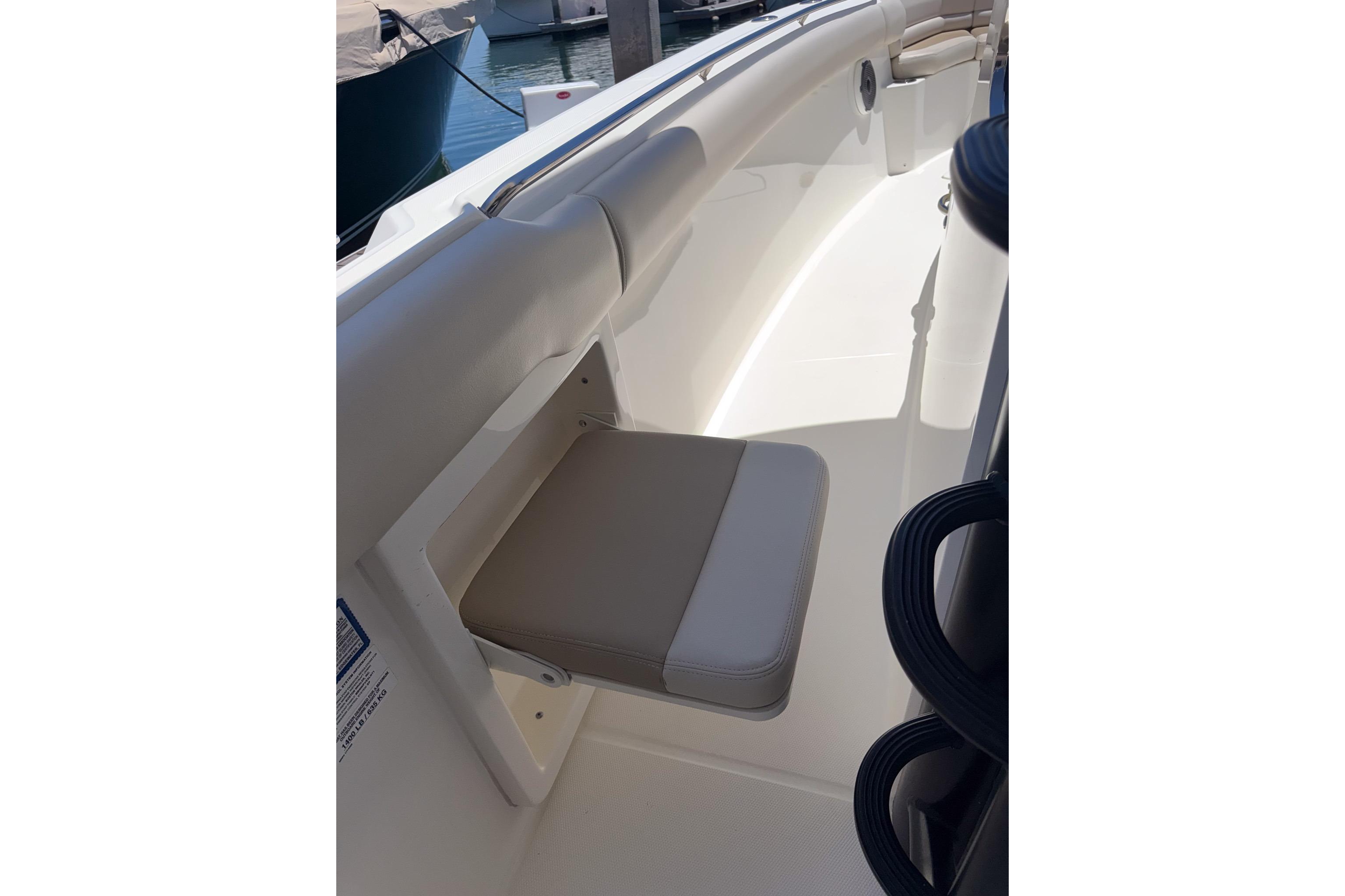 2021 Boston Whaler 330 Outrage boat interior with foldable seat and sleek design.
