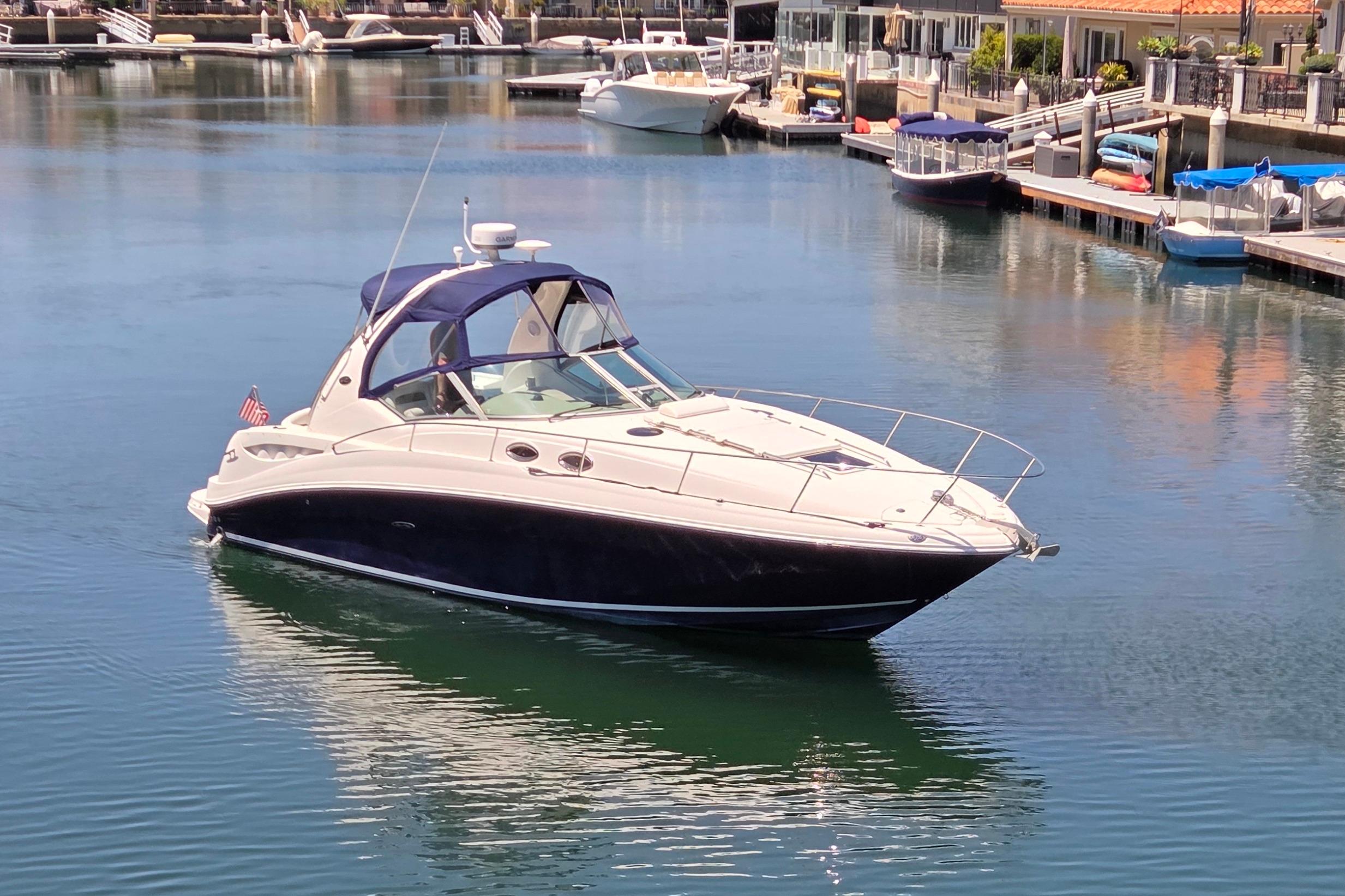 2006 Sea Ray Sundancer 320 yacht docked in a serene marina setting.