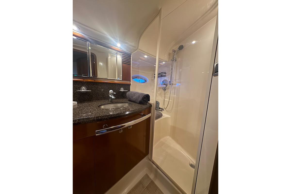 Luxurious bathroom in 2005 Sea Ray 500 Sundancer yacht with modern fixtures and shower.