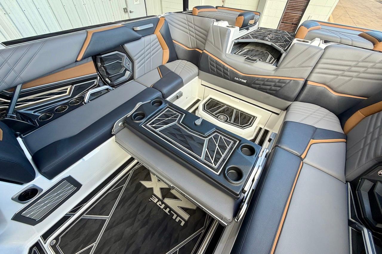 Luxurious interior of 2025 Tigé Ultré 25ZX boat with stylish seating and cup holders.