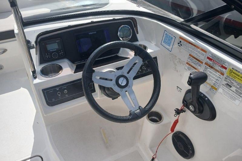 2023 Bayliner DX 2200 boat dashboard with steering wheel and control panel.