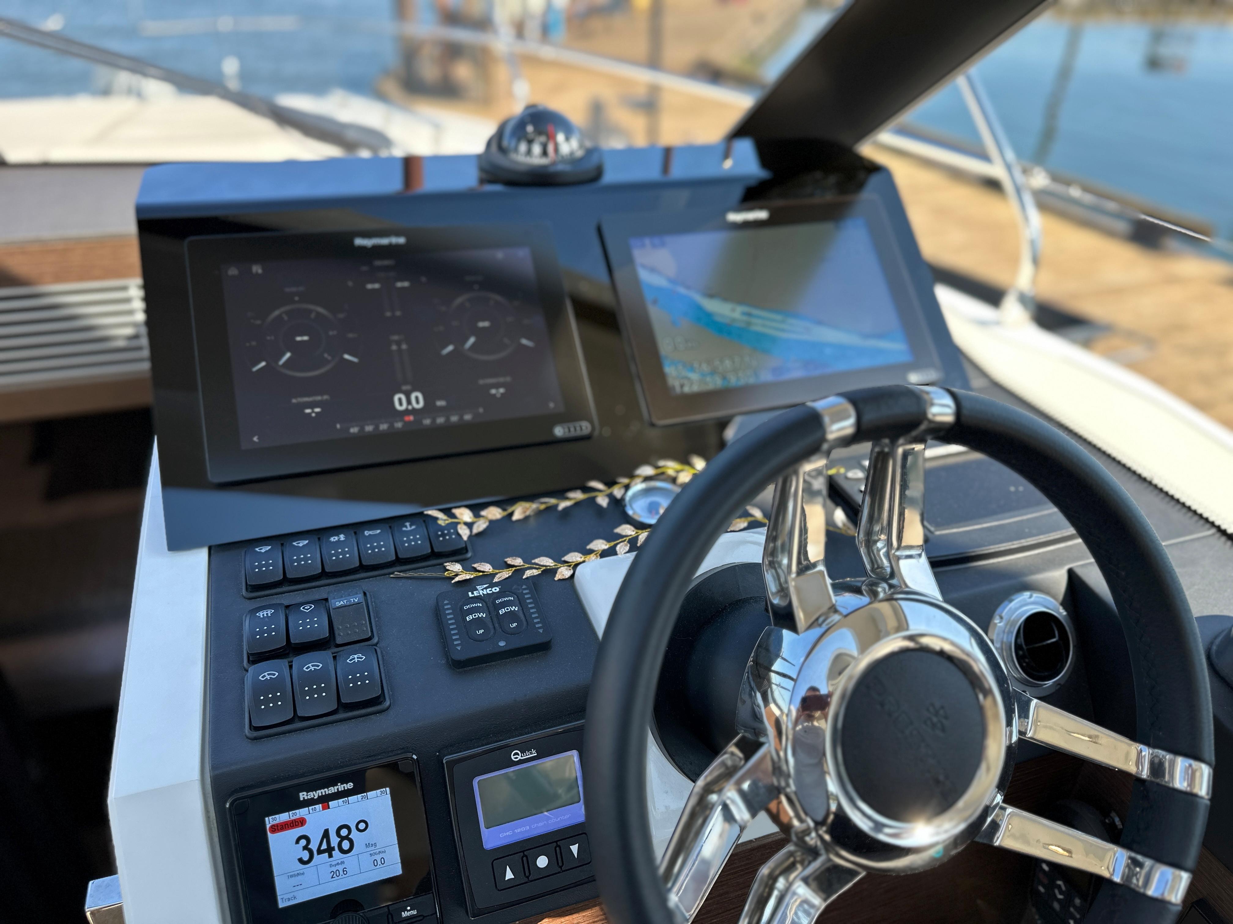 Prestige 420 S 2021 yacht dashboard with navigation screens and steering wheel.