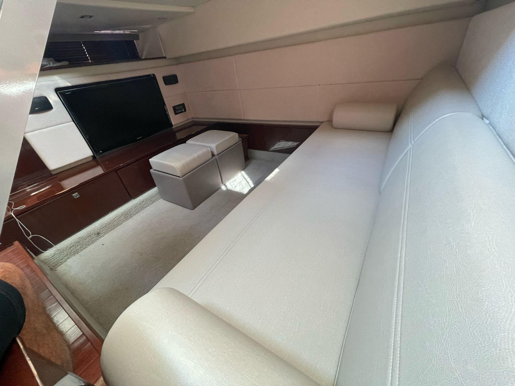 Interior of a 2010 Sea Ray 450 yacht with sofa and TV.